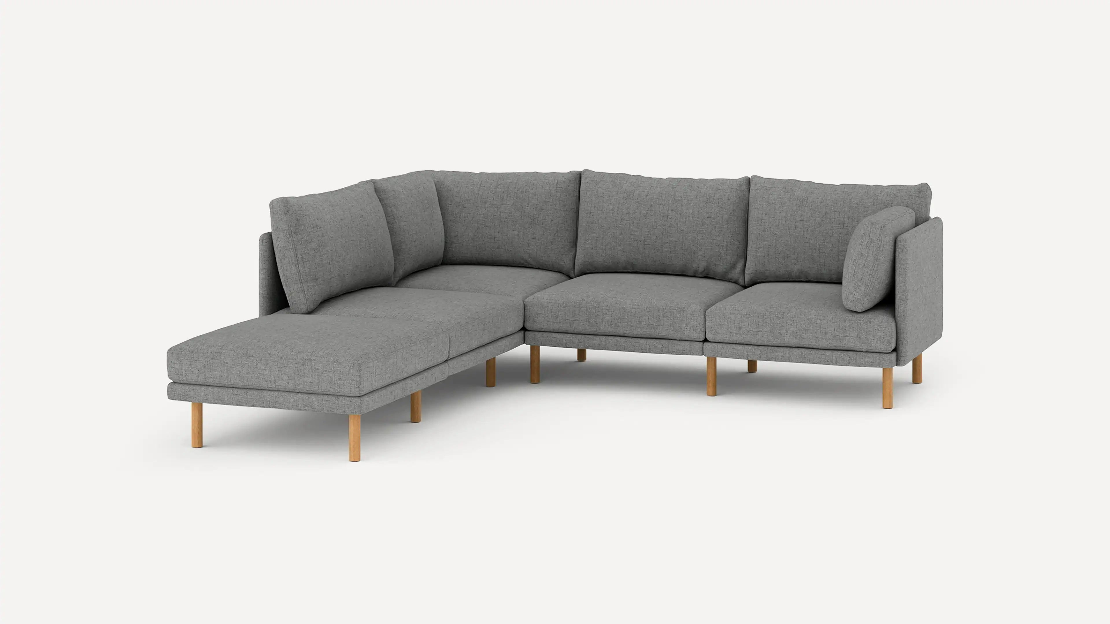 modern l - shaped sectional sofa with light gray fabric upholstery, wooden legs, and clean lines on a white background