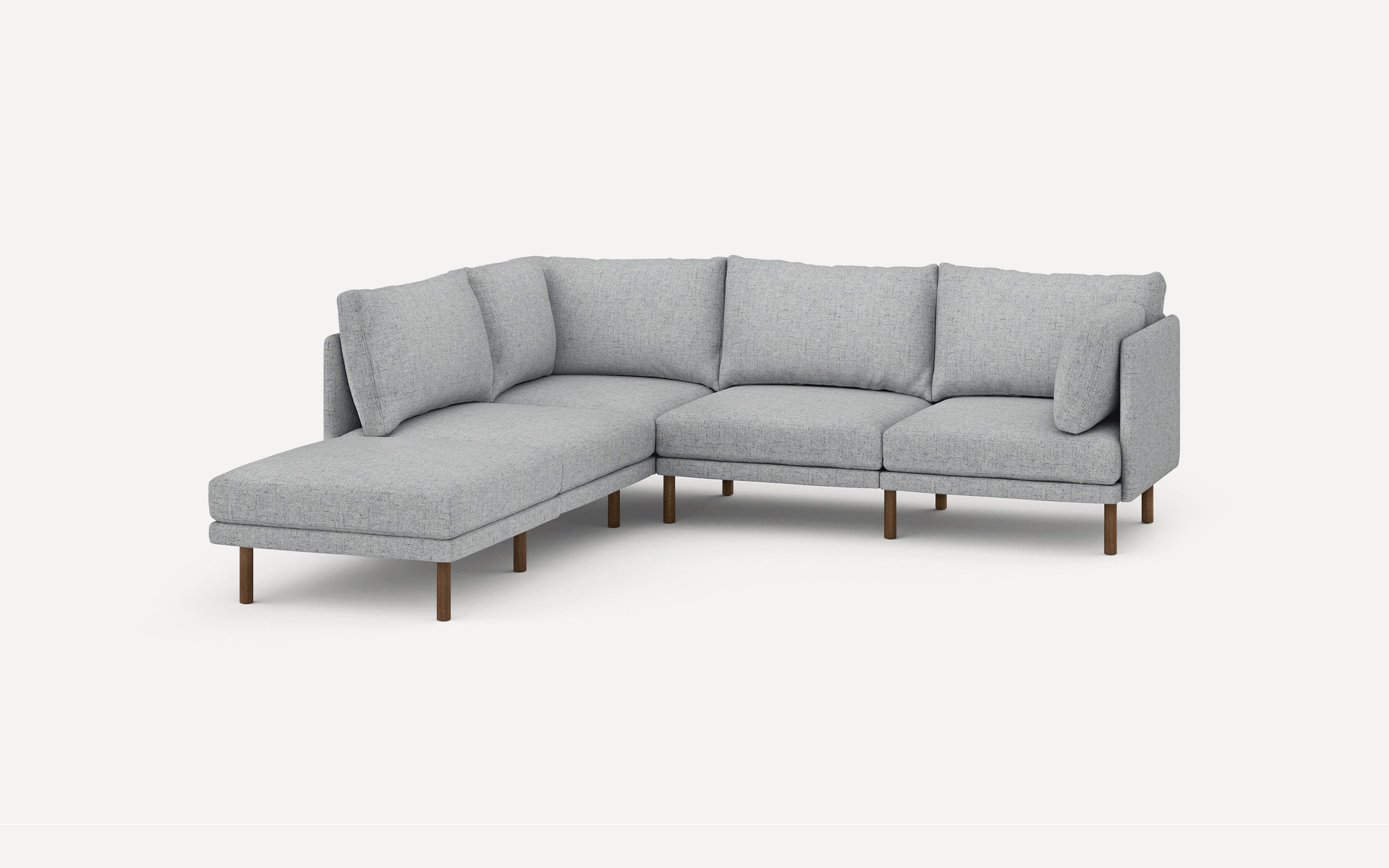 Light gray L-shaped sectional sofa with wooden legs and multiple back cushions against a plain white background.