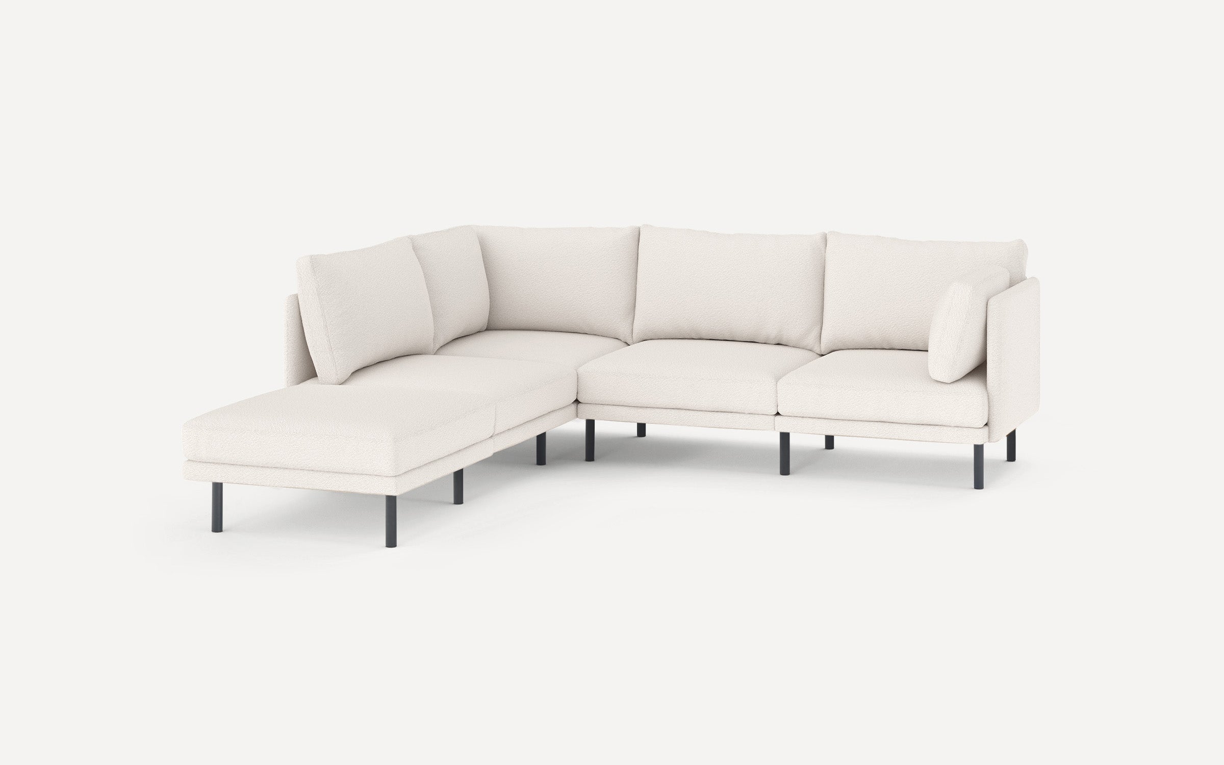 Modern L-shaped sectional sofa in off-white fabric with black metal legs and plush cushions for comfortable seating.
