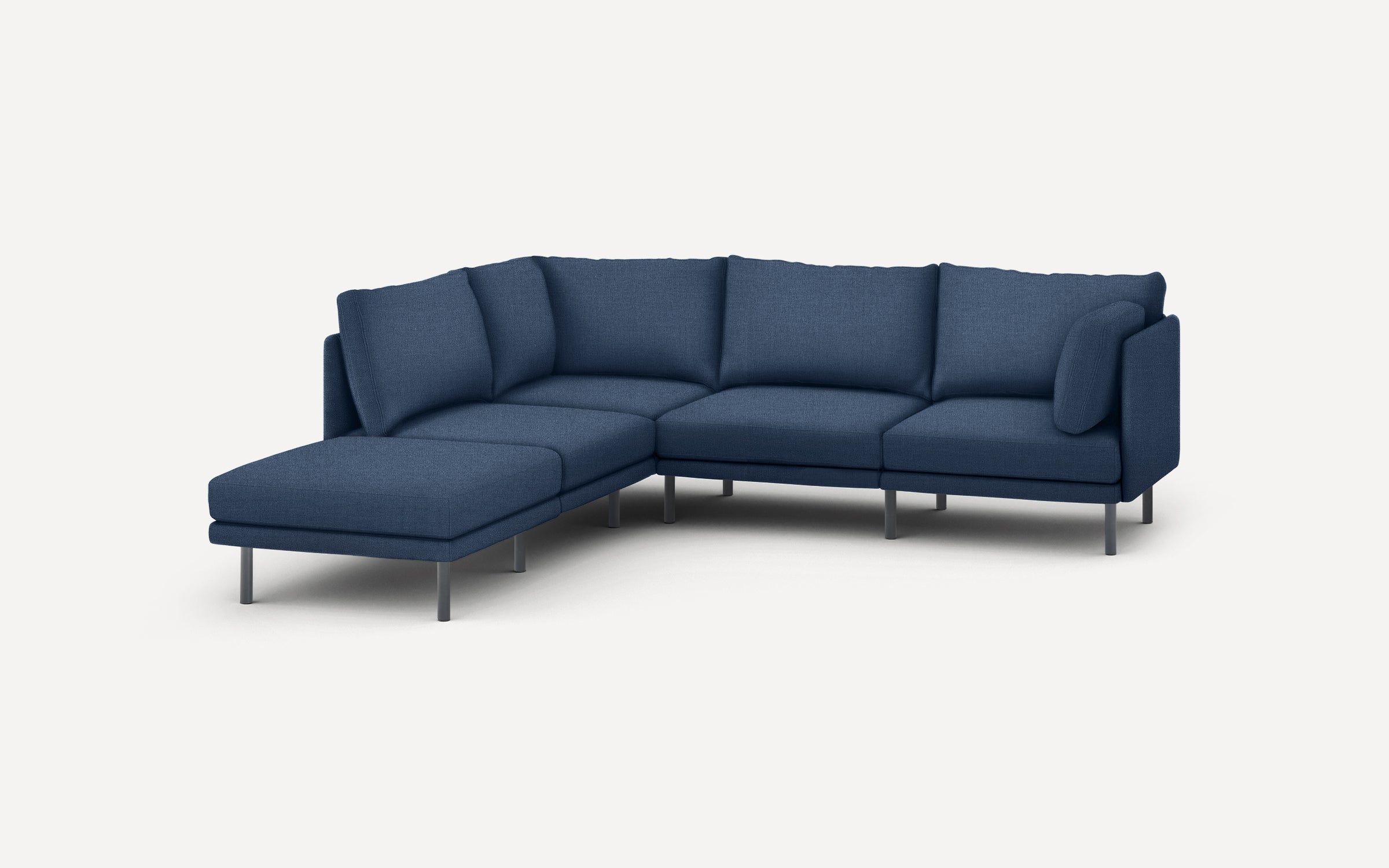 modern navy blue sectional sofa with chaise lounge and matching ottoman, featuring sleek metal legs, and clean lines on a white background