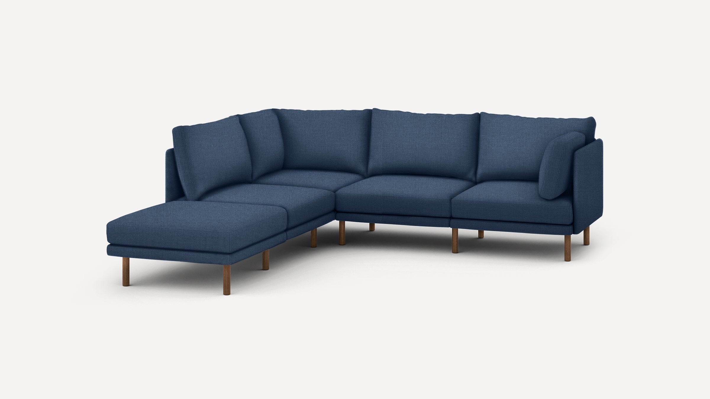 modern navy blue sectional sofa with wooden legs and clean lines on the back, featuring a chaise lounge and matching ottoman