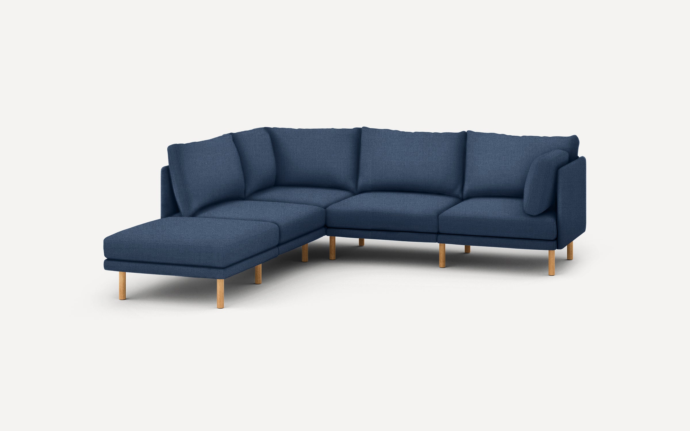 modern navy blue sectional sofa with wooden legs and clean lines on the back, featuring a chaise lounge and matching ottoman