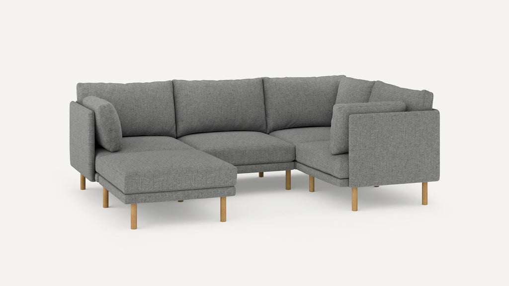 Modern gray fabric sectional sofa with wooden legs, featuring a chaise lounge and cushioned backrests for comfort.