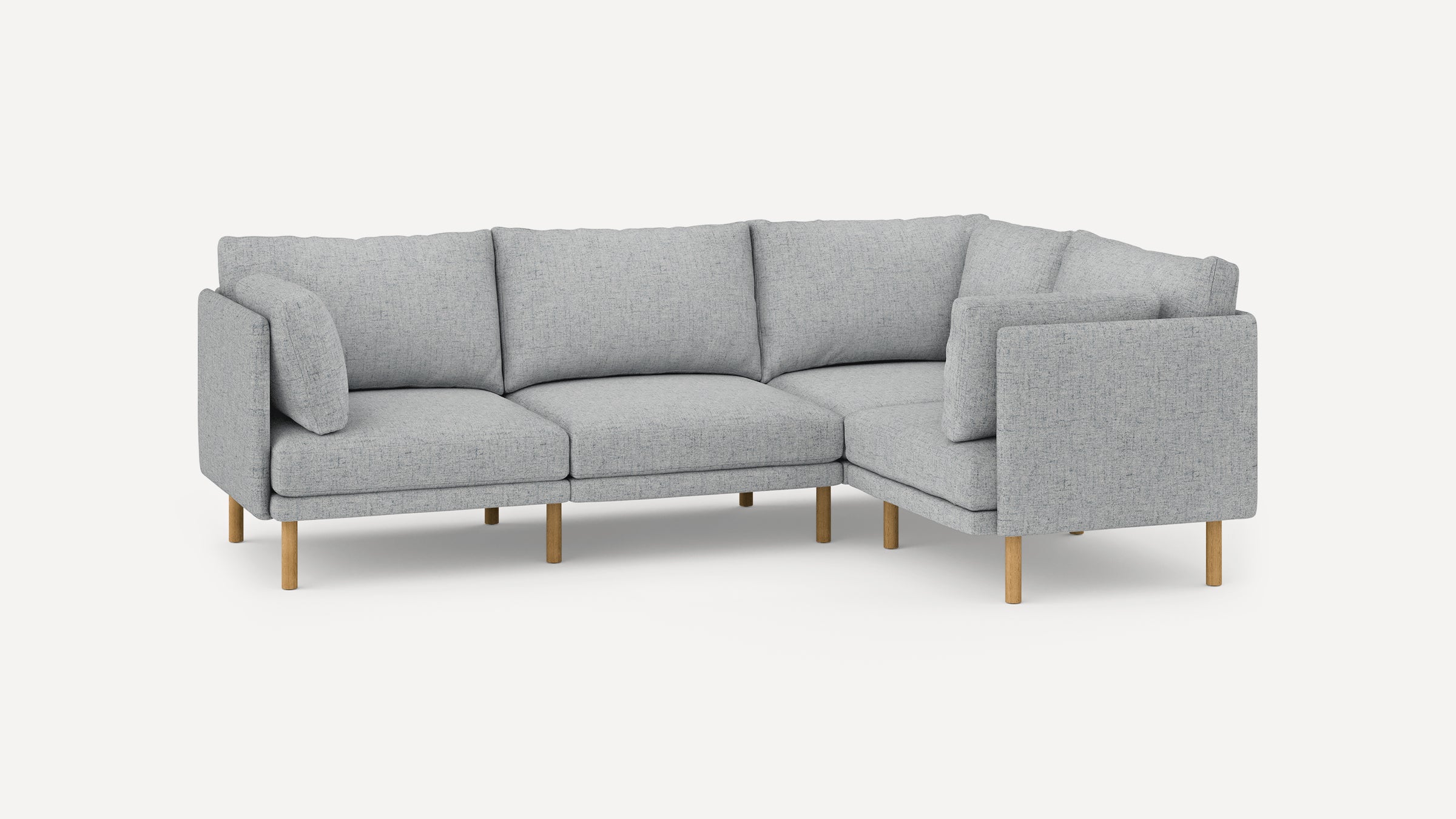 Light gray modern L-shaped sectional sofa with soft cushions and wooden legs, designed for spacious, comfortable seating.