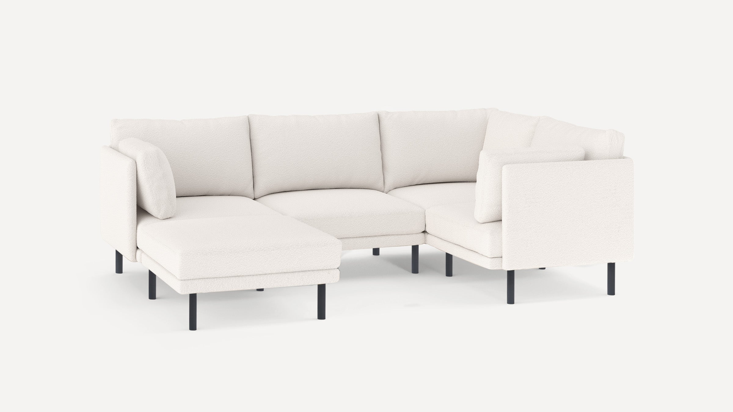 Modern white fabric sectional sofa with black metal legs, featuring a chaise lounge and plush cushions.