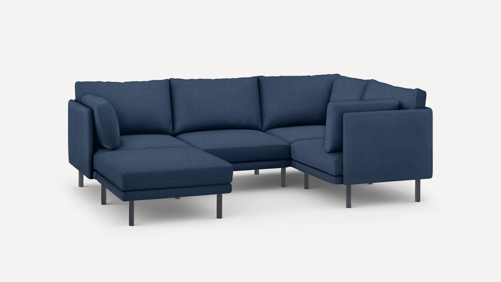 Modern sectional sofa with navy blue fabric upholstery, slim metal legs, and multiple cushions for seating and comfort.