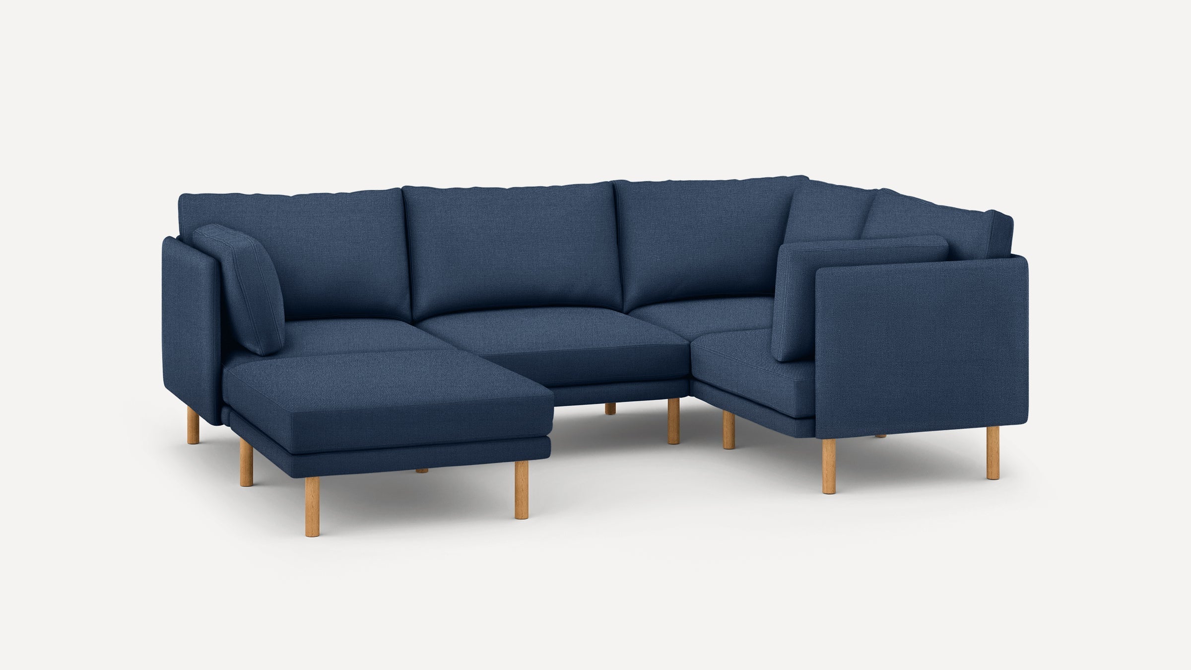 Modern navy blue fabric sectional sofa with wooden legs, corner design, and plush cushions for comfortable seating.