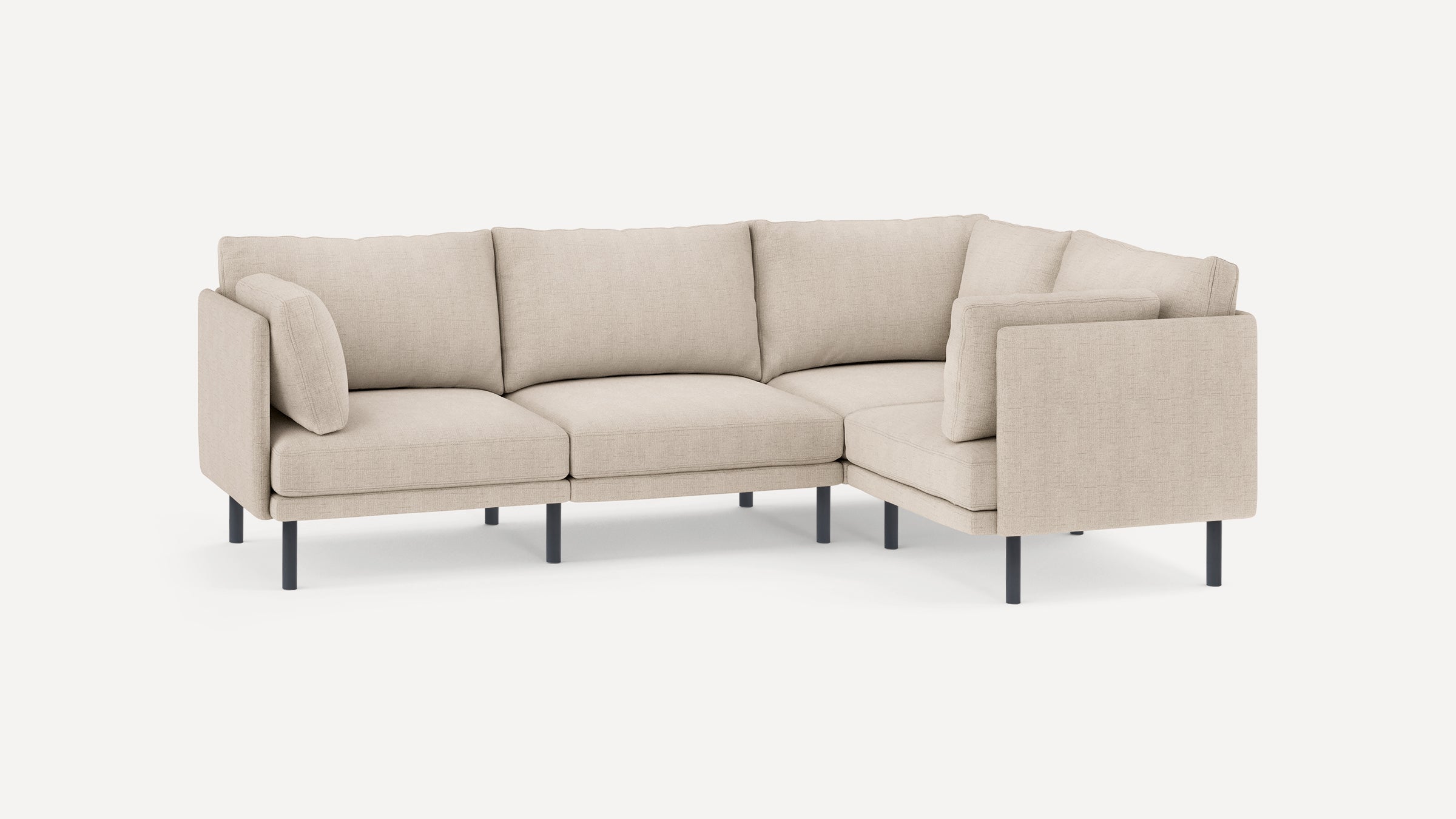 Beige fabric L-shaped sectional sofa with black slim metal legs and removable cushions, modern and minimalist design.