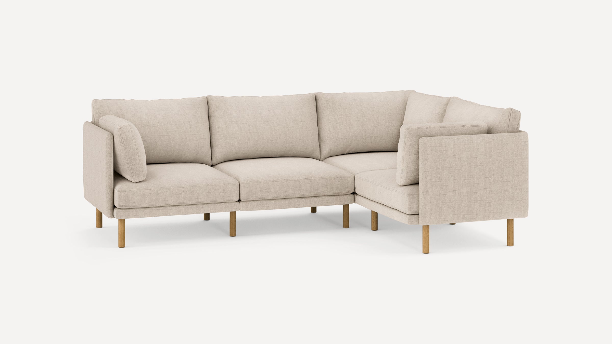 Modern beige fabric sectional sofa with wooden legs, featuring three seat cushions and plush backrests in an L-shaped design.