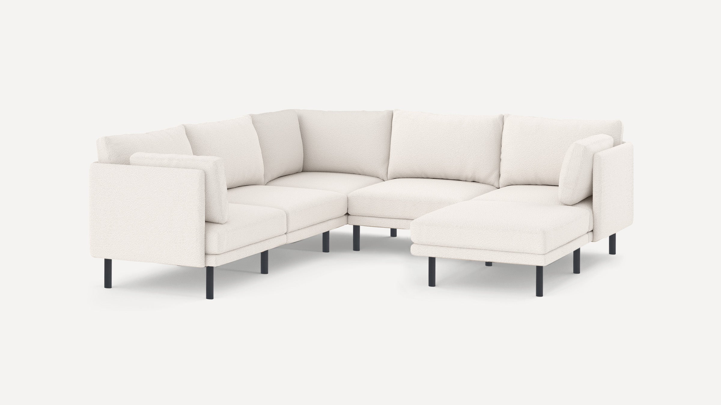 Modern white sectional sofa with plush cushions and black metal legs, featuring an L-shaped design and a chaise lounge on the right side.