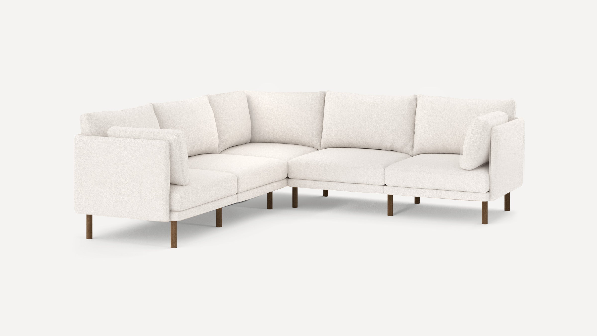 modern l - shaped sectional sofa with beige upholstery and wooden legs, featuring clean lines and clean lines on the back, on a