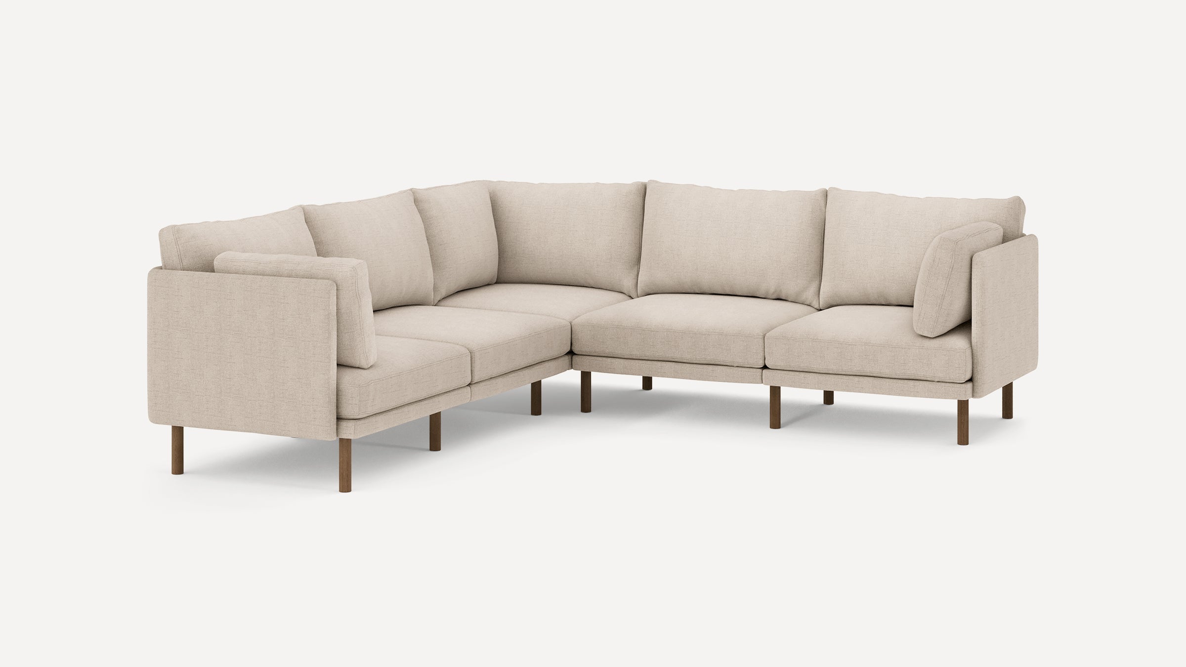 Beige fabric L-shaped sectional sofa with wooden legs and multiple cushioned seats and backrests.