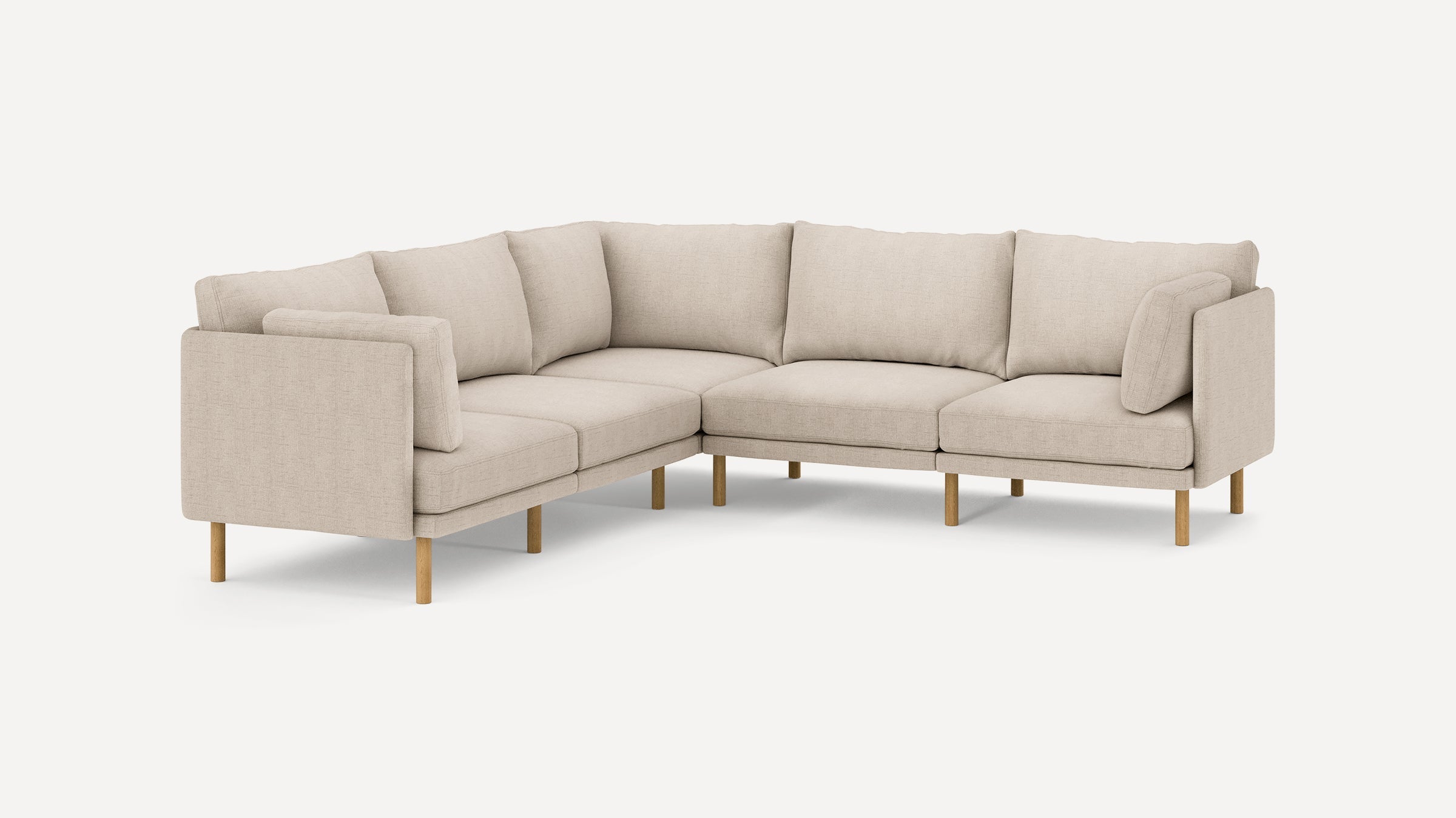 beige l - shaped sectional sofa with clean lines and wooden legs, featuring clean lines and clean lines on the back, and clean lines on the