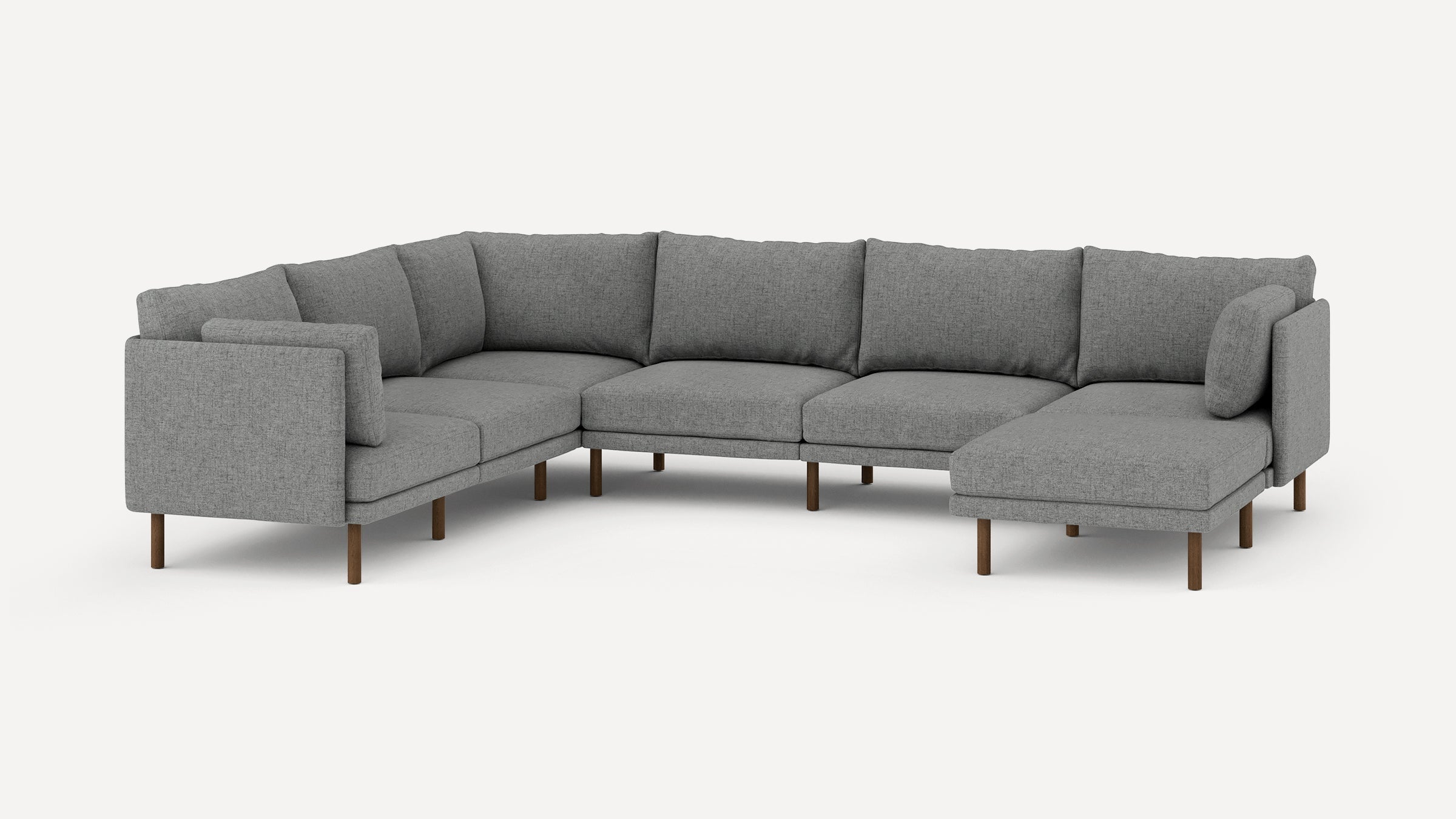 Modern L-shaped sectional sofa upholstered in gray fabric with wooden legs and multiple cushioned backs and seats.