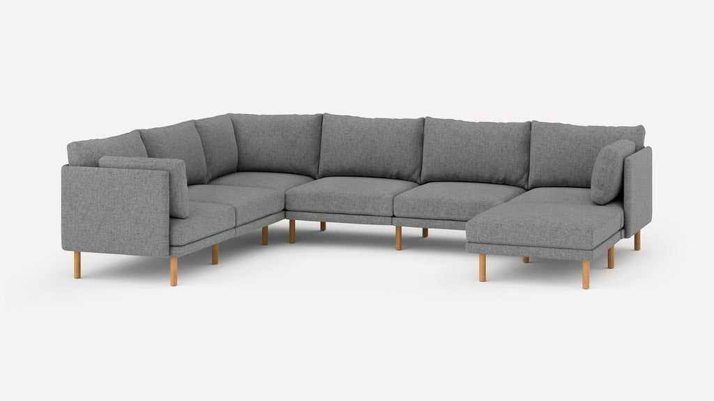 Modern gray fabric sectional sofa with wooden legs, featuring multiple seat and back cushions in an L-shaped design.