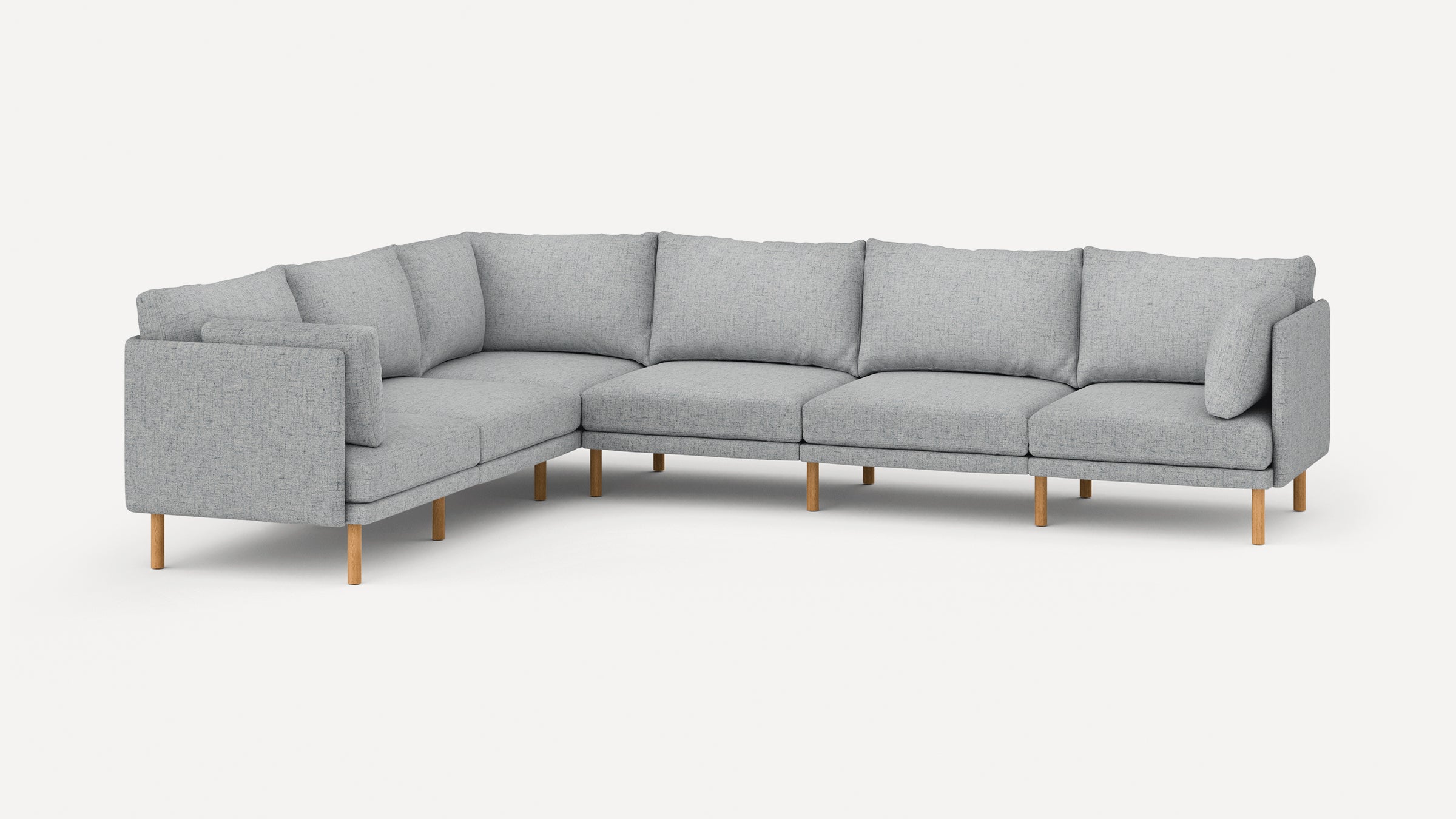 Light gray fabric L-shaped sectional sofa with wooden legs and cushioned back and armrests.