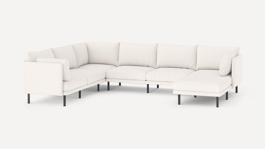 Modern white L-shaped sectional sofa with plush cushions and black metal legs, designed for spacious living rooms.
