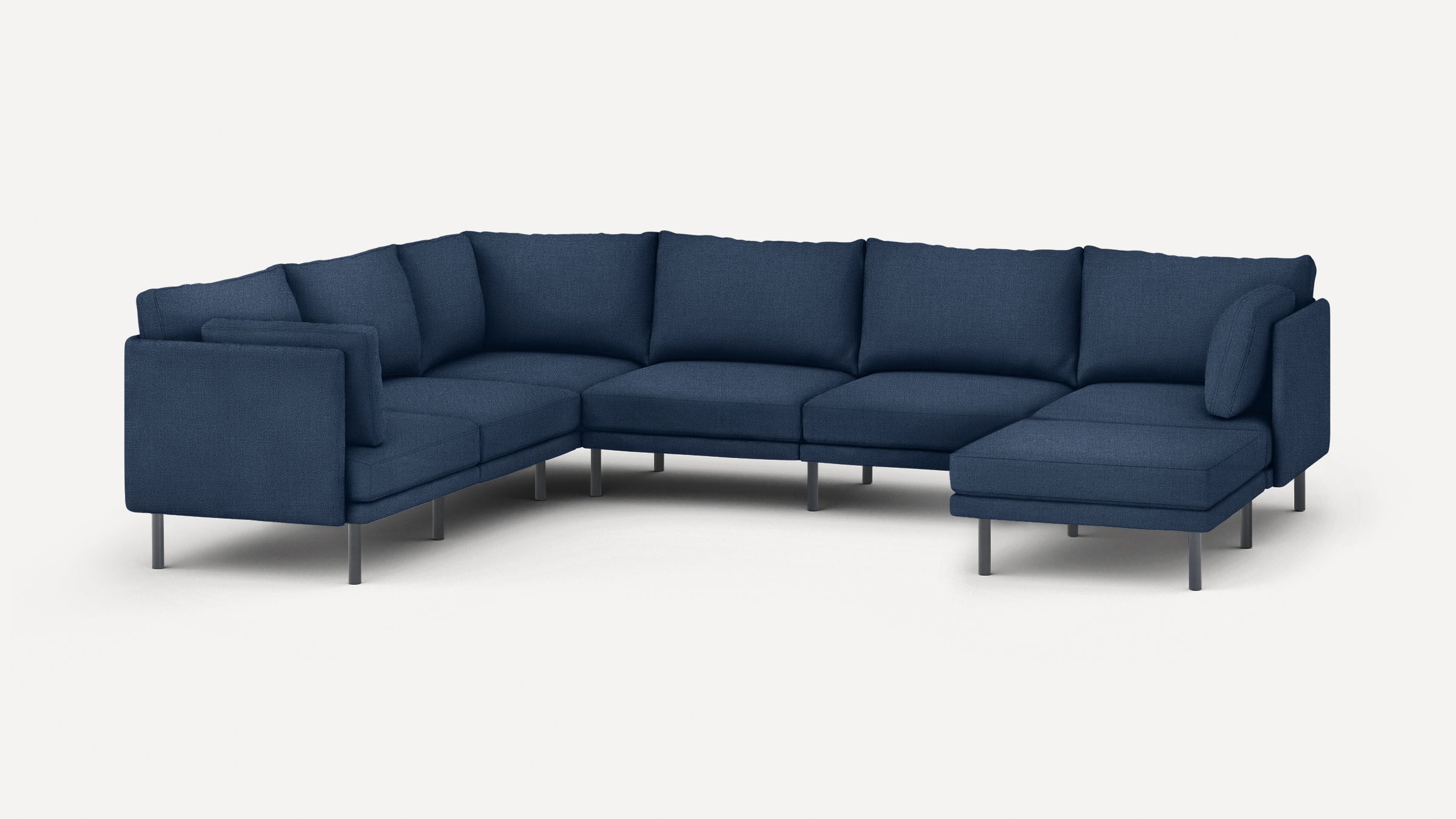 Large modern navy blue sectional sofa with metal legs and plush cushions on a white background.