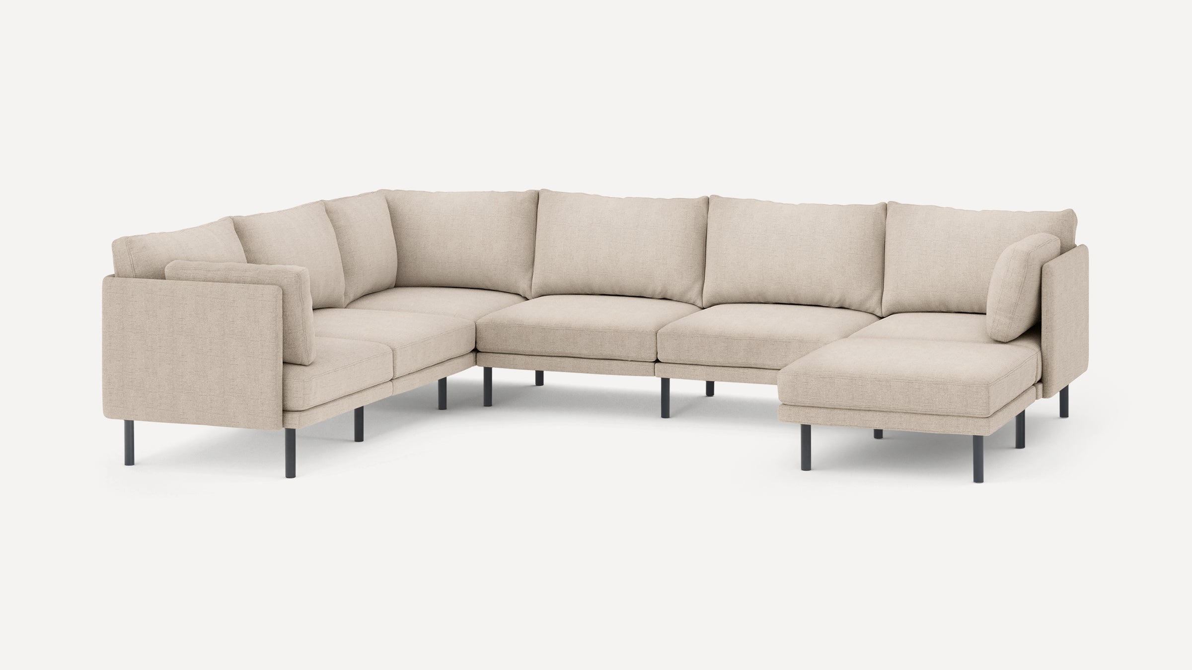 Beige fabric U-shaped sectional sofa with sleek black metal legs and multiple plush back and side cushions.