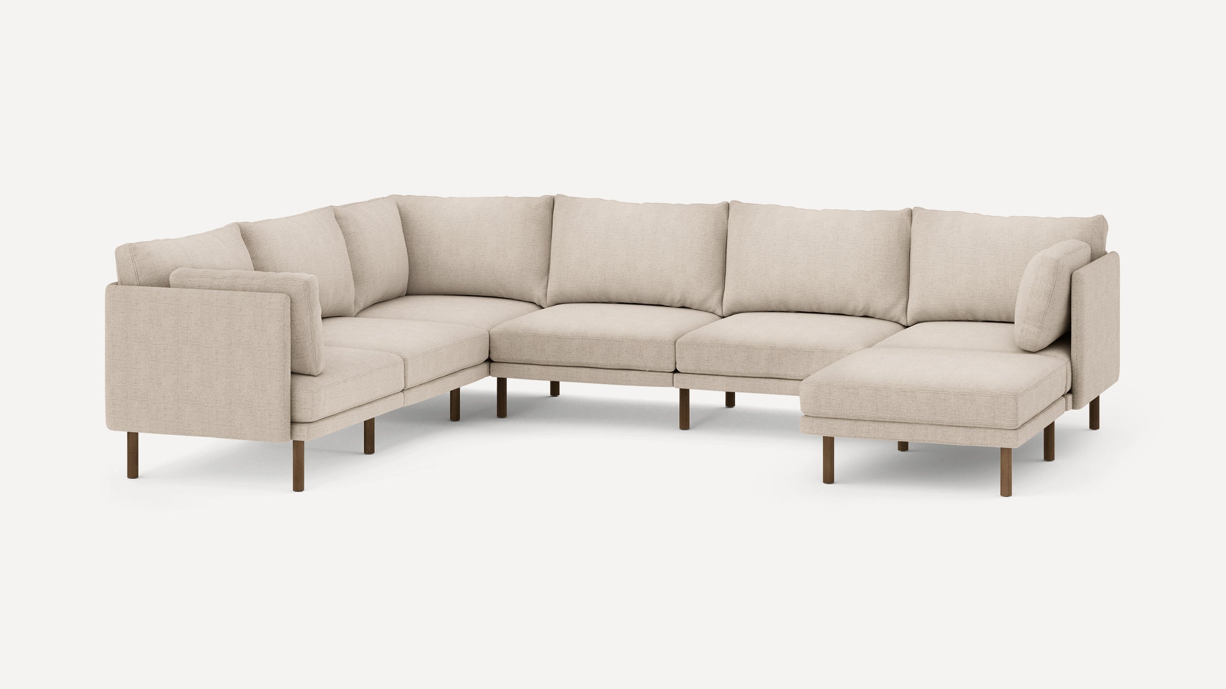 Beige fabric L-shaped sectional sofa with wooden legs and multiple cushions, offering spacious modern seating.