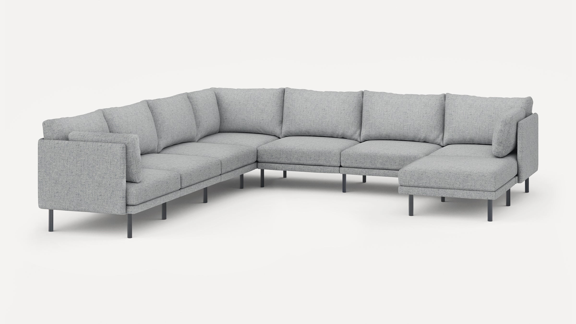 Large modern L-shaped sectional sofa in light gray fabric with metal legs and plush back cushions.