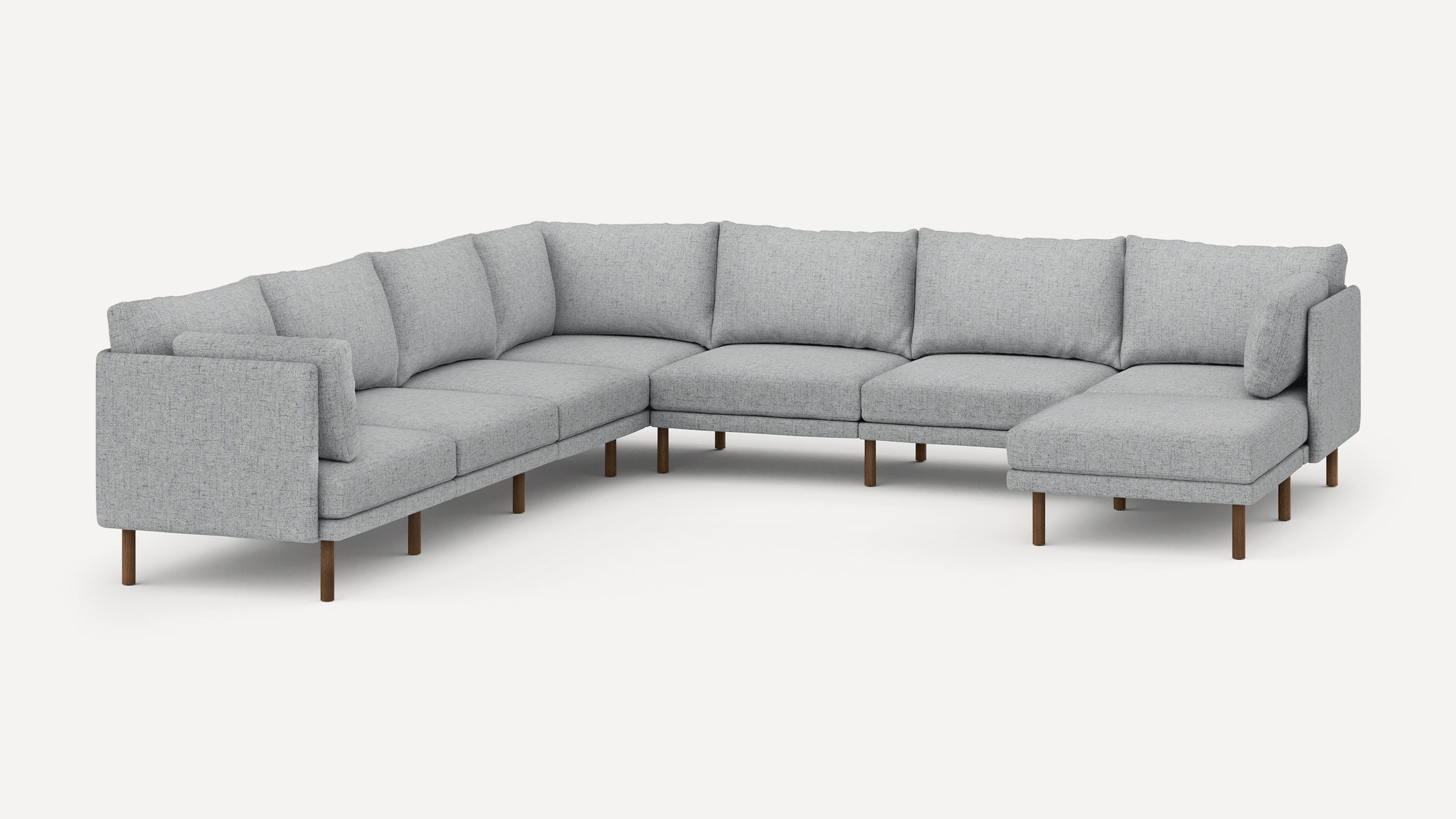 Modern L-shaped sectional sofa in light gray fabric with wooden legs, featuring cushioned seats and backrests.