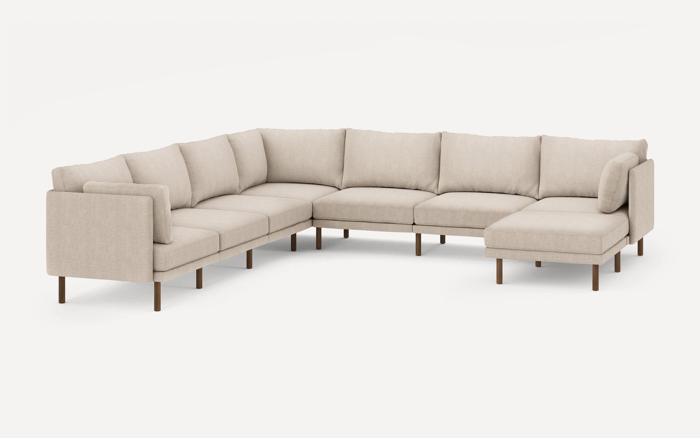 Beige fabric L-shaped sectional sofa with wooden legs, consisting of multiple cushioned seats and backrests for spacious seating.