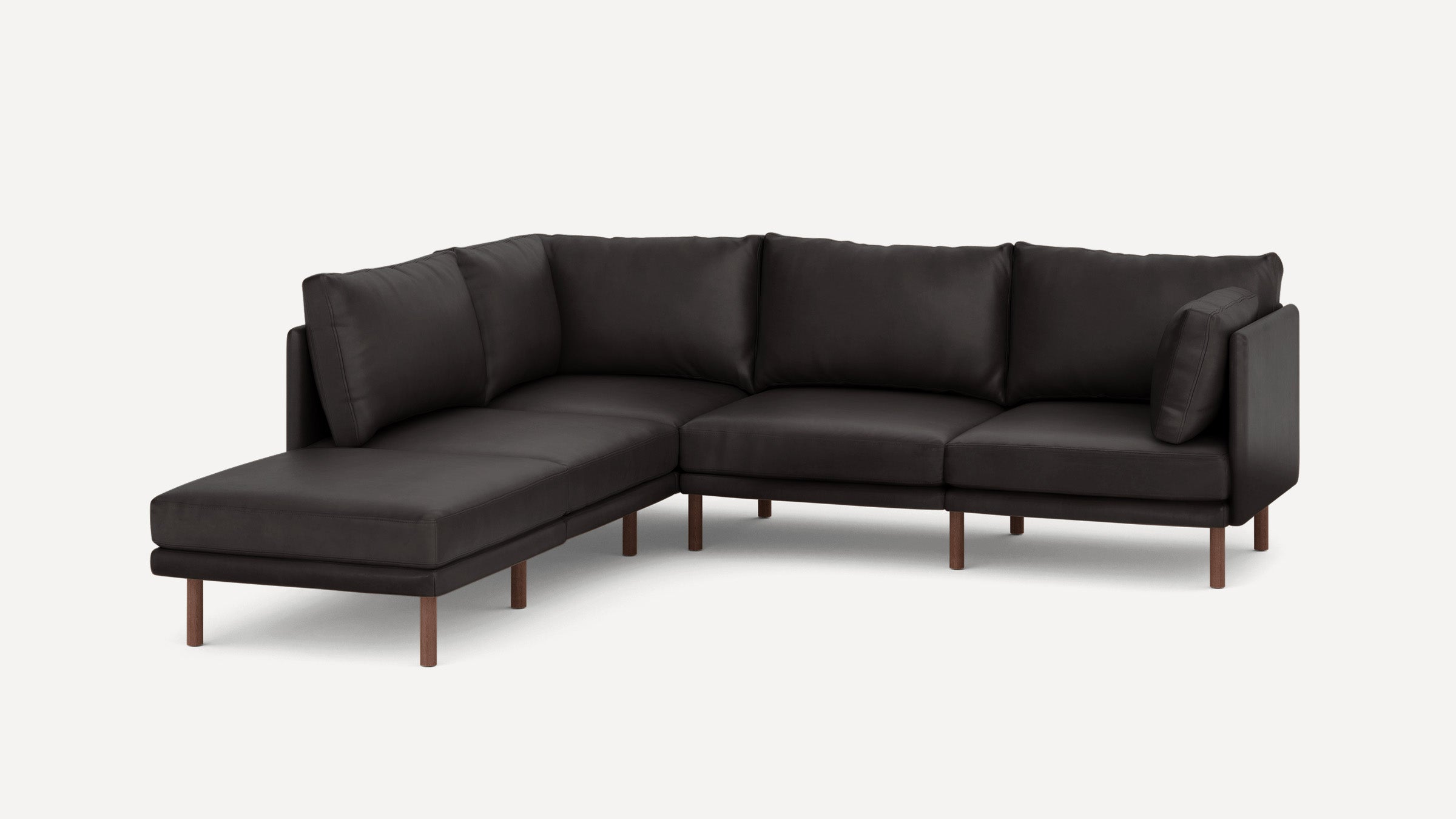 Modern dark gray fabric L-shaped sectional sofa with wooden legs and plush back cushions on a white background.