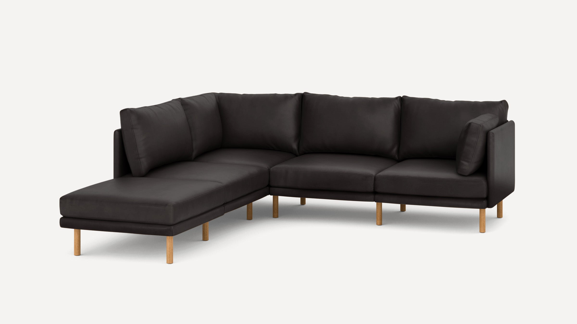 Dark gray L-shaped sectional sofa with plush cushions and light wooden legs on a plain white background.