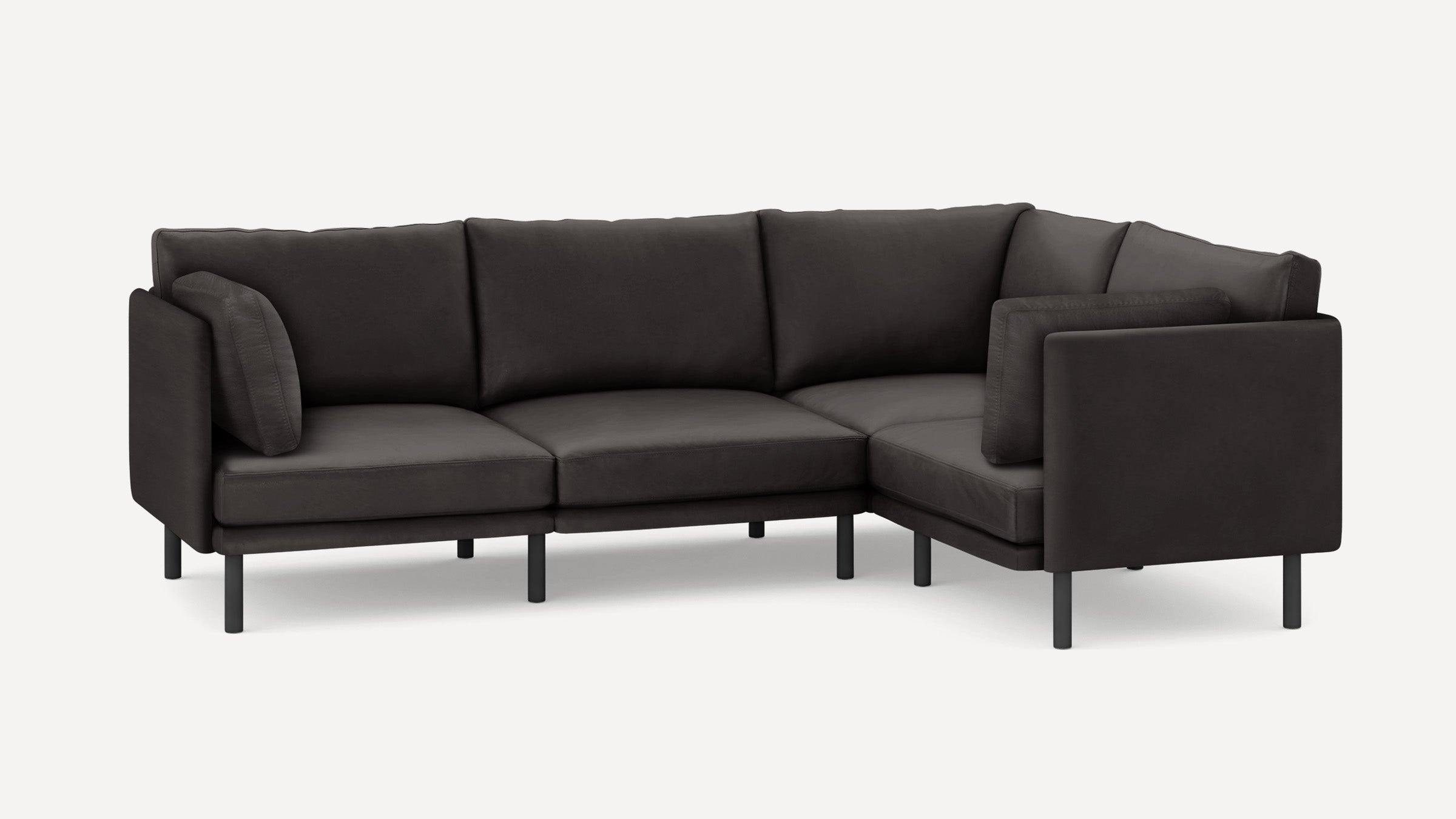 Modern L-shaped sectional sofa in dark gray fabric with slim black metal legs and cushioned backrests and armrests.
