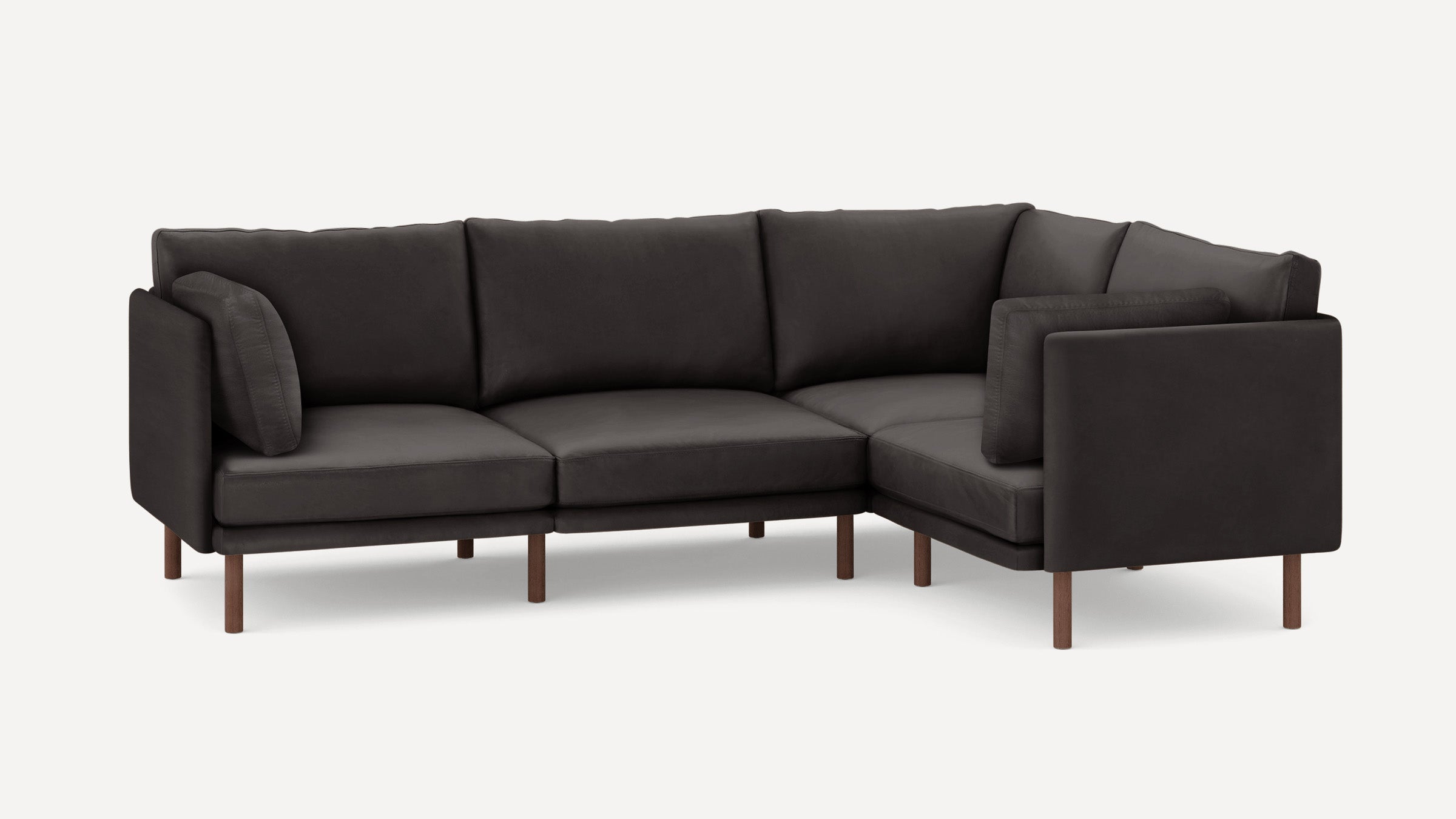 Dark gray L-shaped sectional sofa with wooden legs and matching cushions on a white background.
