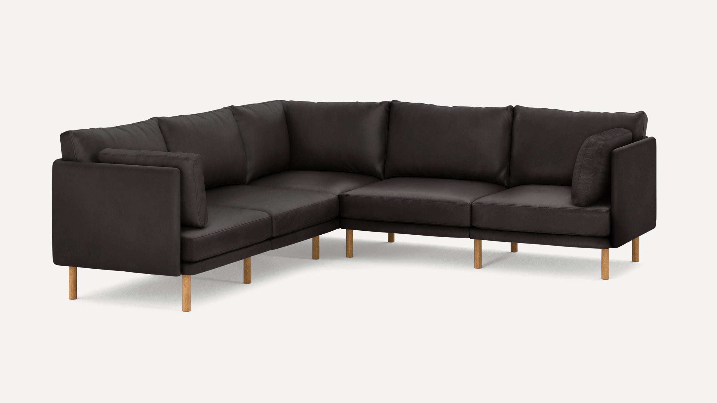 Modern L-shaped dark gray sectional sofa with wooden legs, plush cushions, and clean, minimalist design.
