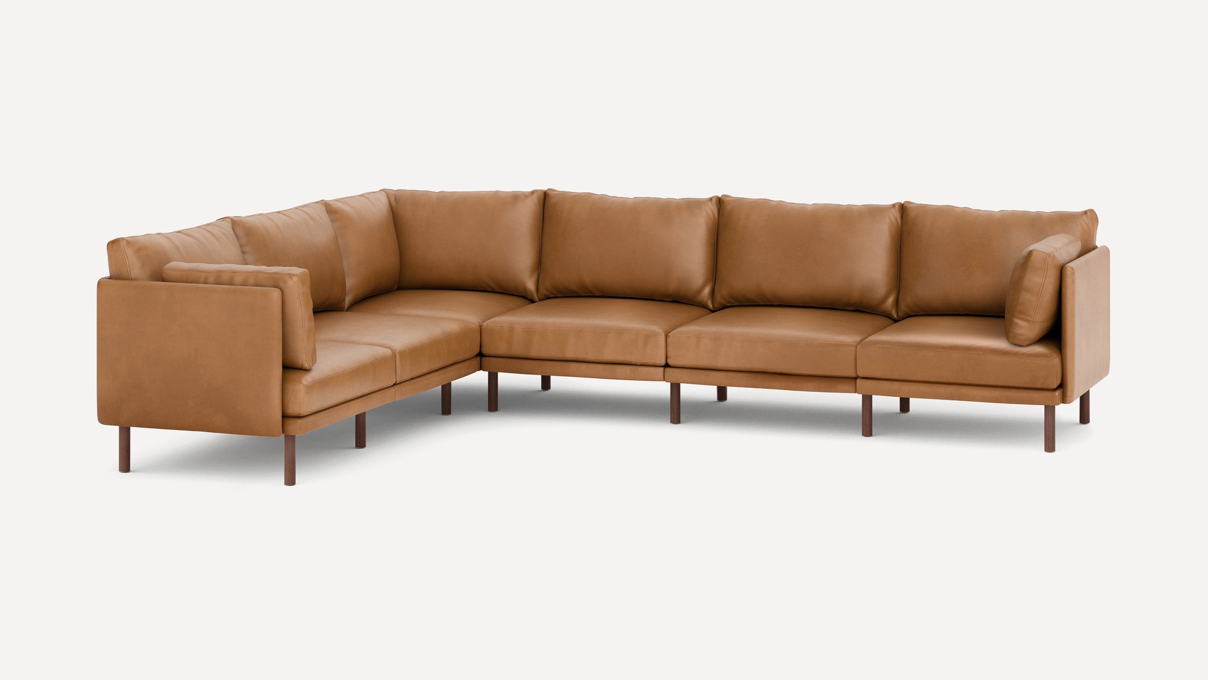 Modern tan leather L-shaped sectional sofa with clean lines, cushioned back and seat, and wooden legs on a white background.