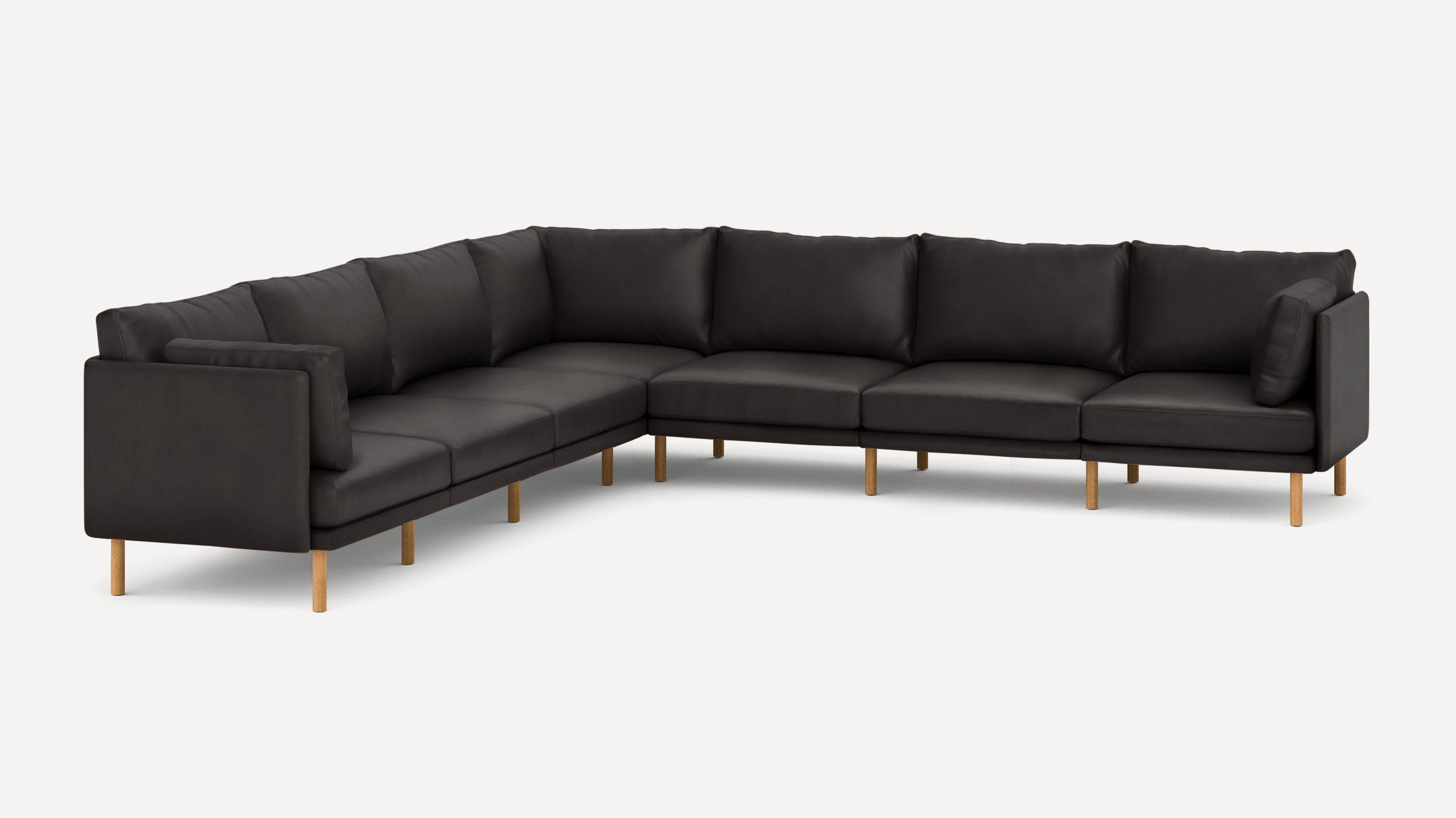 Large black L-shaped sectional sofa with wooden legs and plush back cushions on a white background.