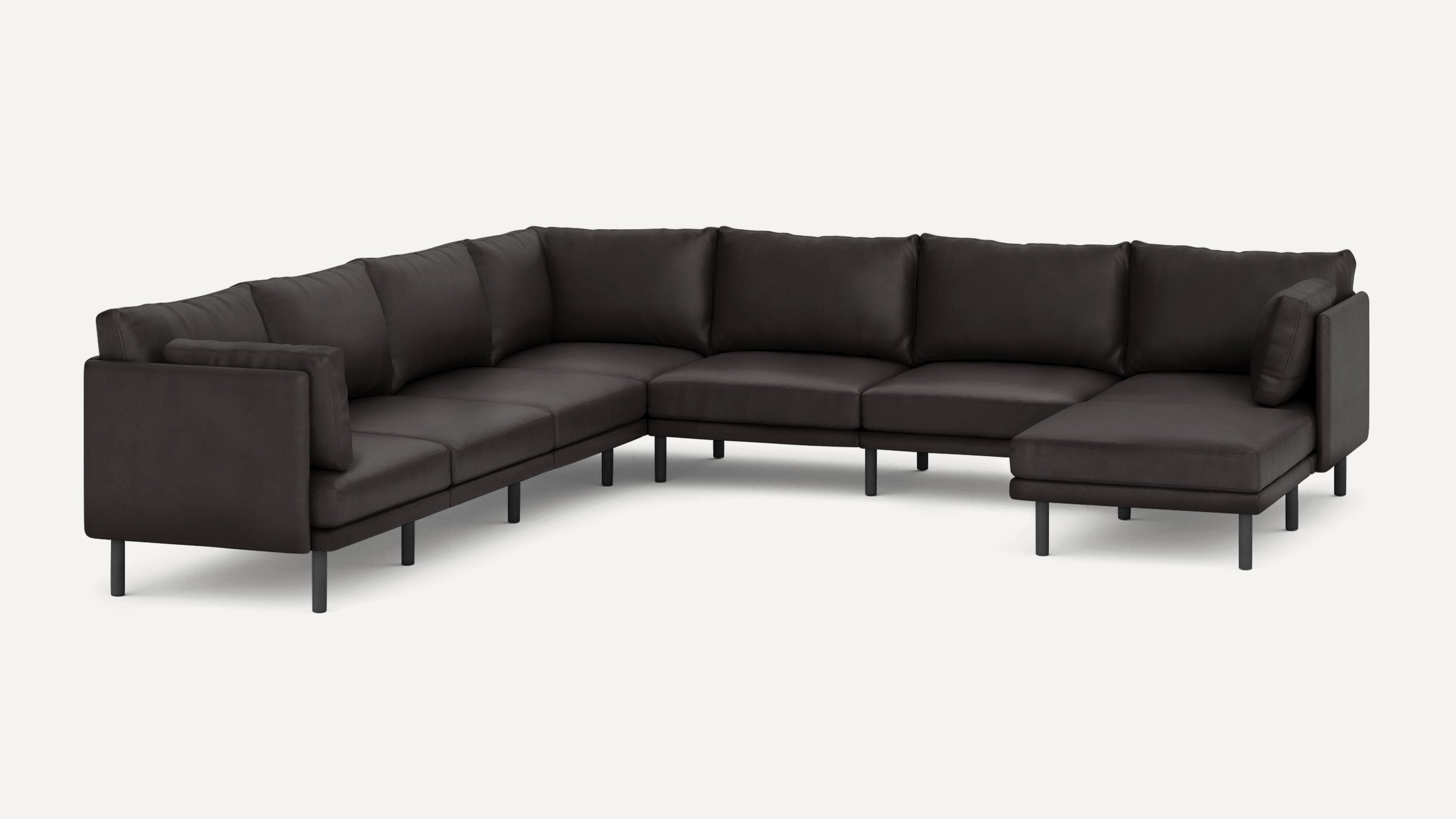 Large modern dark gray sectional sofa with multiple cushions and slim black legs on a plain white background.