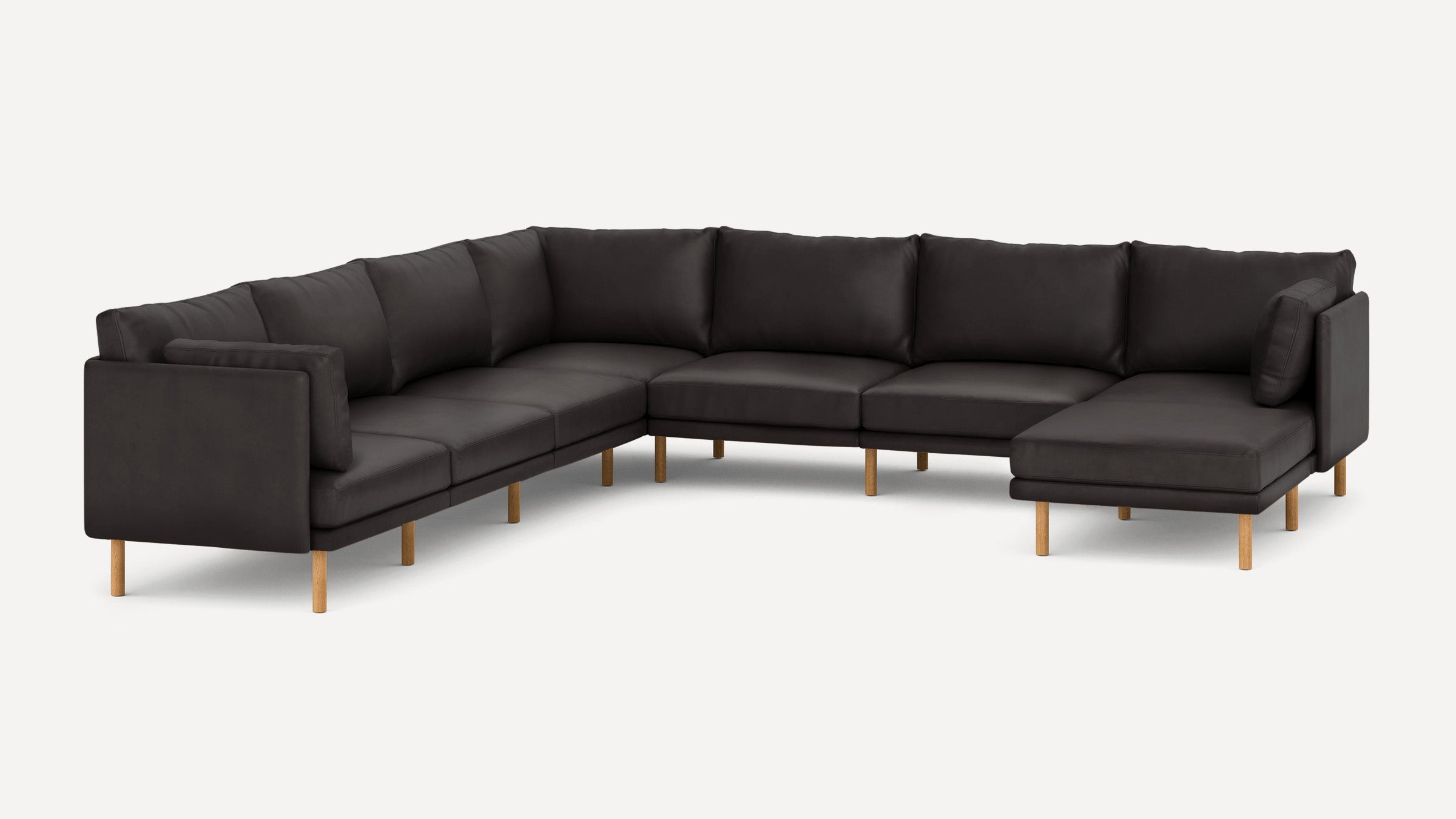 Large modern sectional sofa in dark gray fabric with wooden legs, featuring plush cushions and a right-side chaise lounge.
