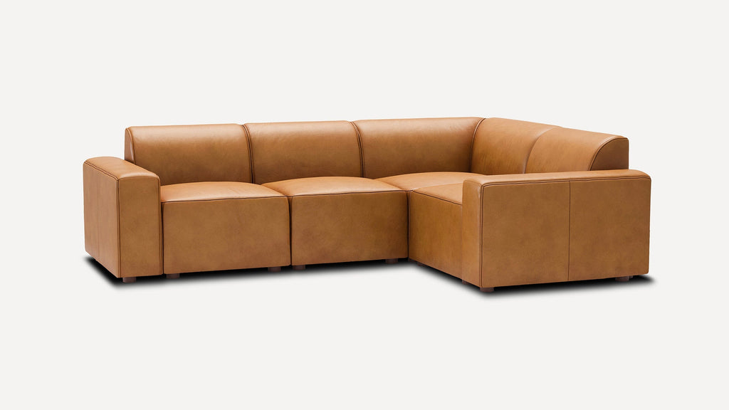 modern tan leather l - shaped sectional sofa with clean lines and clean lines on the back, featuring a center cushion and matching ottoman