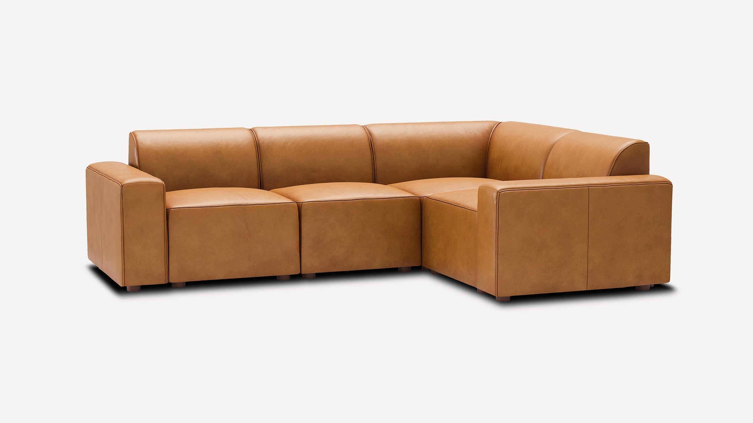 modern tan leather l - shaped sectional sofa with clean lines and clean lines on the back, featuring a center cushion and matching ottoman