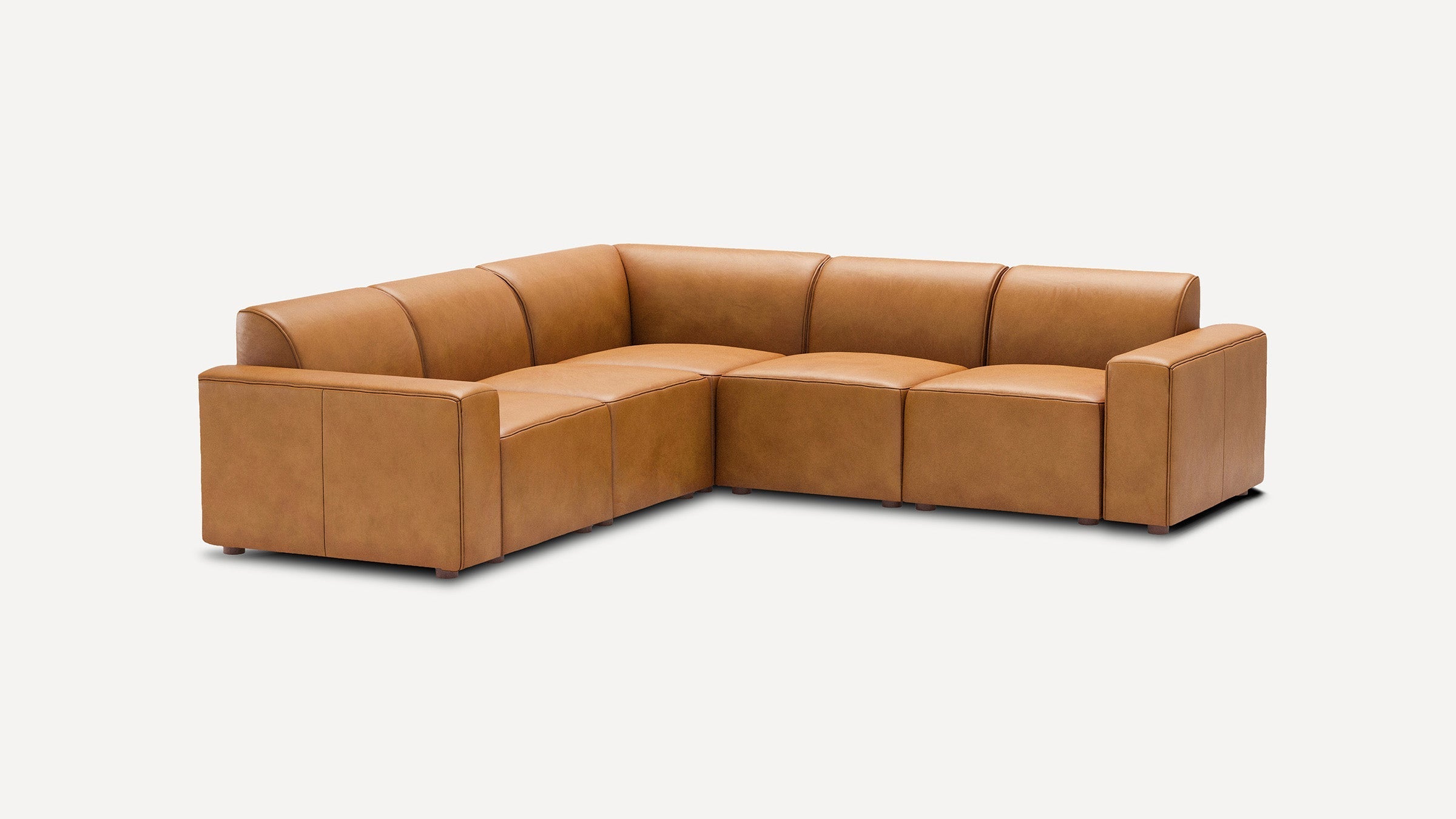 modern l - shaped tan leather sectional sofa with clean lines and rounded cushions, isolated against a white background