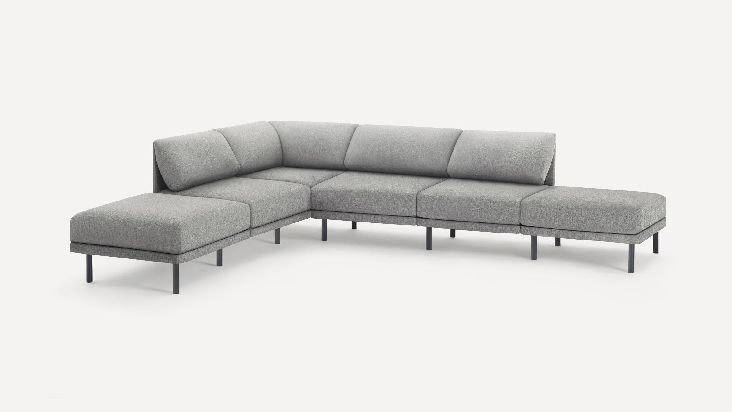 Modern light grey fabric L-shaped sectional sofa with low back cushions and slim black metal legs on white background.