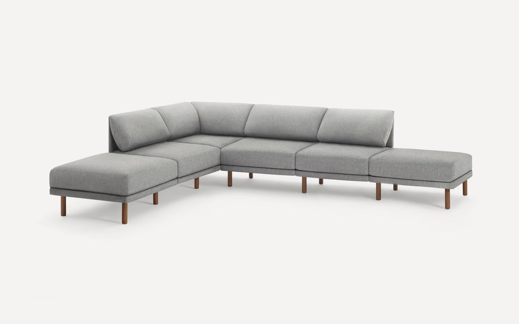 Modern L-shaped sectional sofa with light gray fabric upholstery and wooden legs, designed for spacious seating.