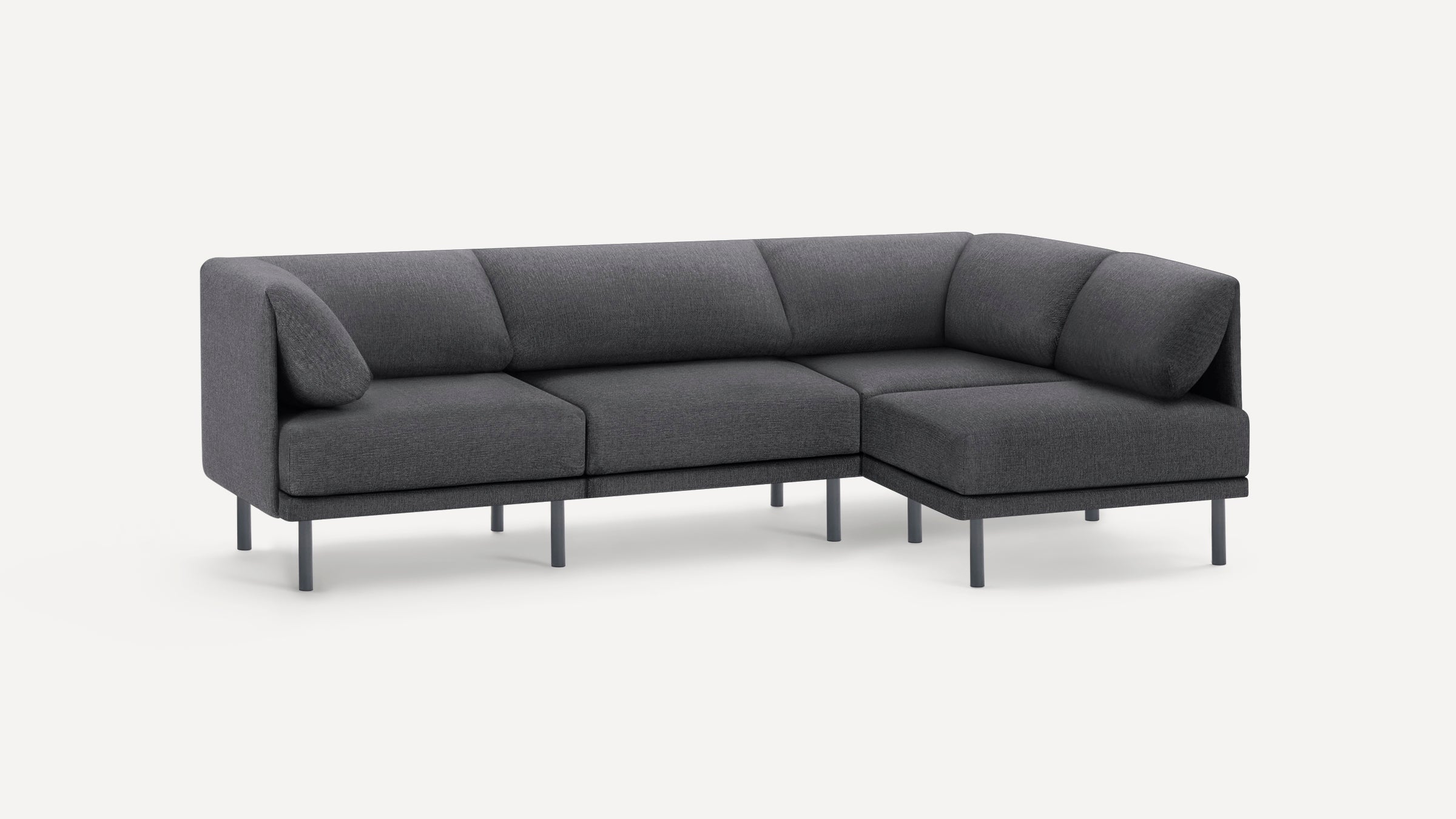 Modern dark gray fabric sectional sofa with clean lines, cushioned seats, backrests, and slim metal legs.