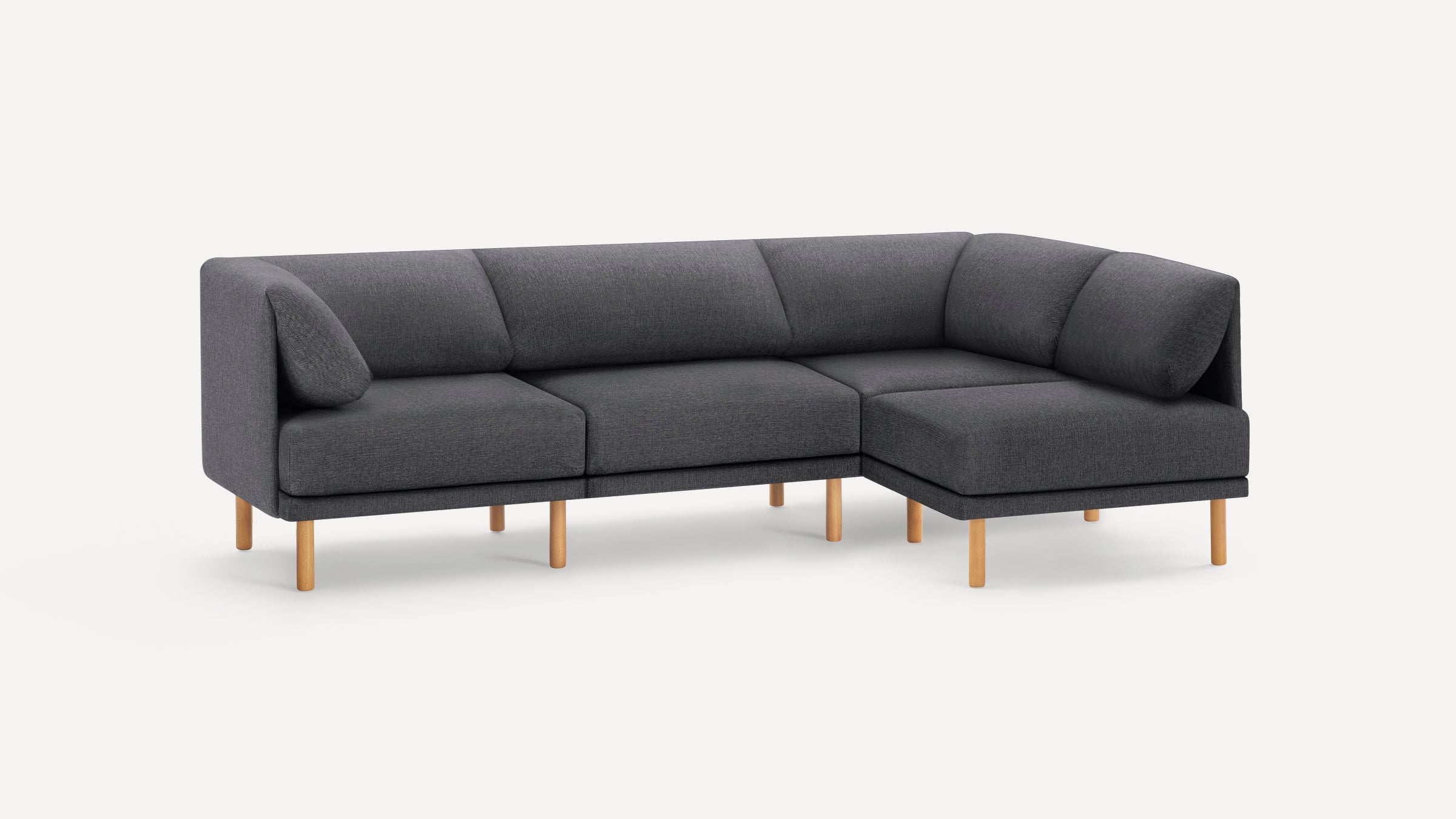 Modern L-shaped dark gray fabric sectional sofa with wooden legs and clean, minimalist design.