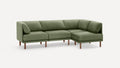 Modern L-shaped sectional sofa with green fabric upholstery and wooden legs against a plain white background.
