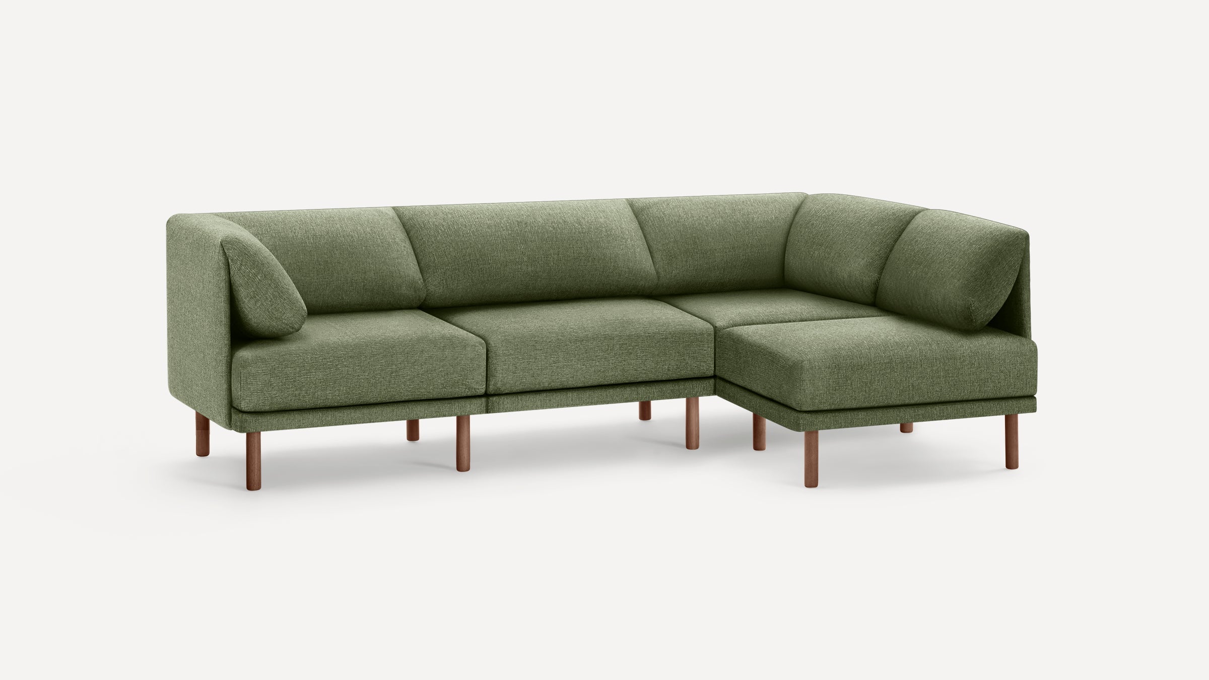 Modern L-shaped sectional sofa with green fabric upholstery and wooden legs against a plain white background.