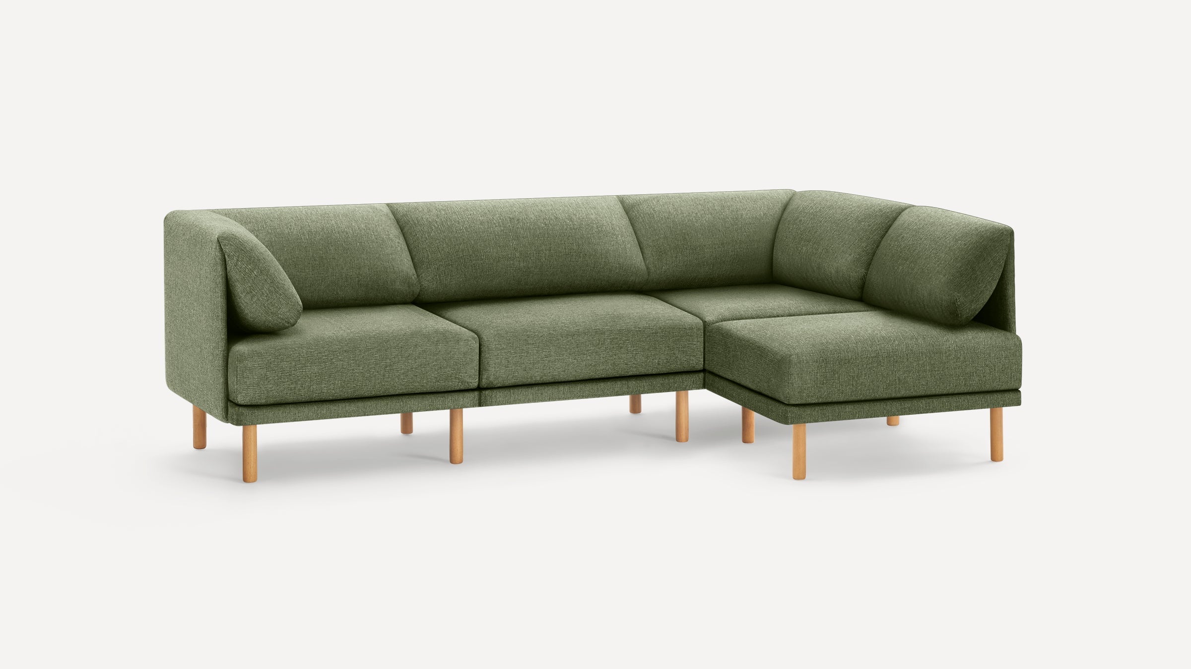 Green fabric L-shaped sectional sofa with wooden legs, featuring cushioned seats and backrests, minimalistic modern design.
