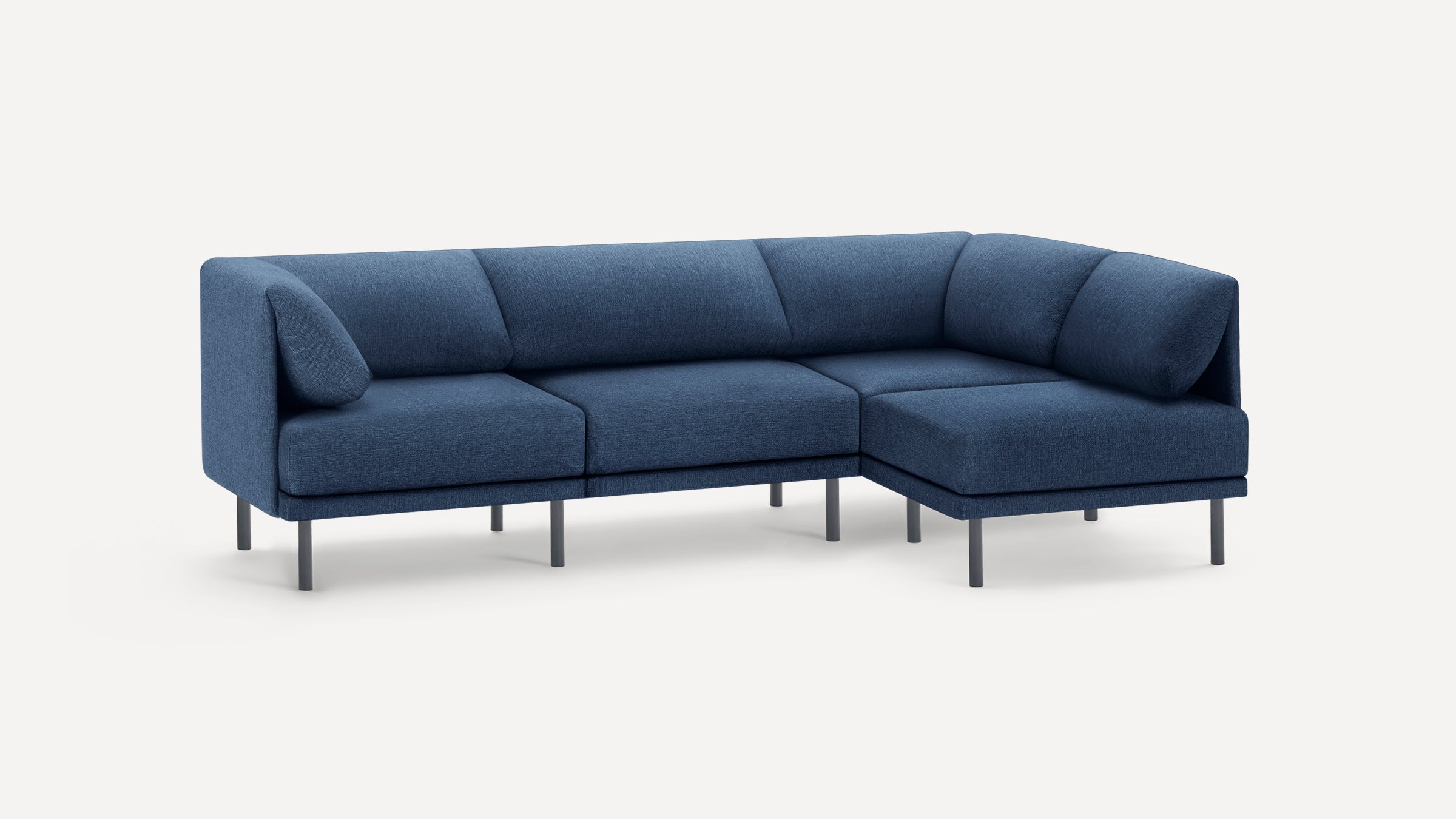 Modern L-shaped sectional sofa with deep blue fabric upholstery and slim black metal legs on a plain white background.