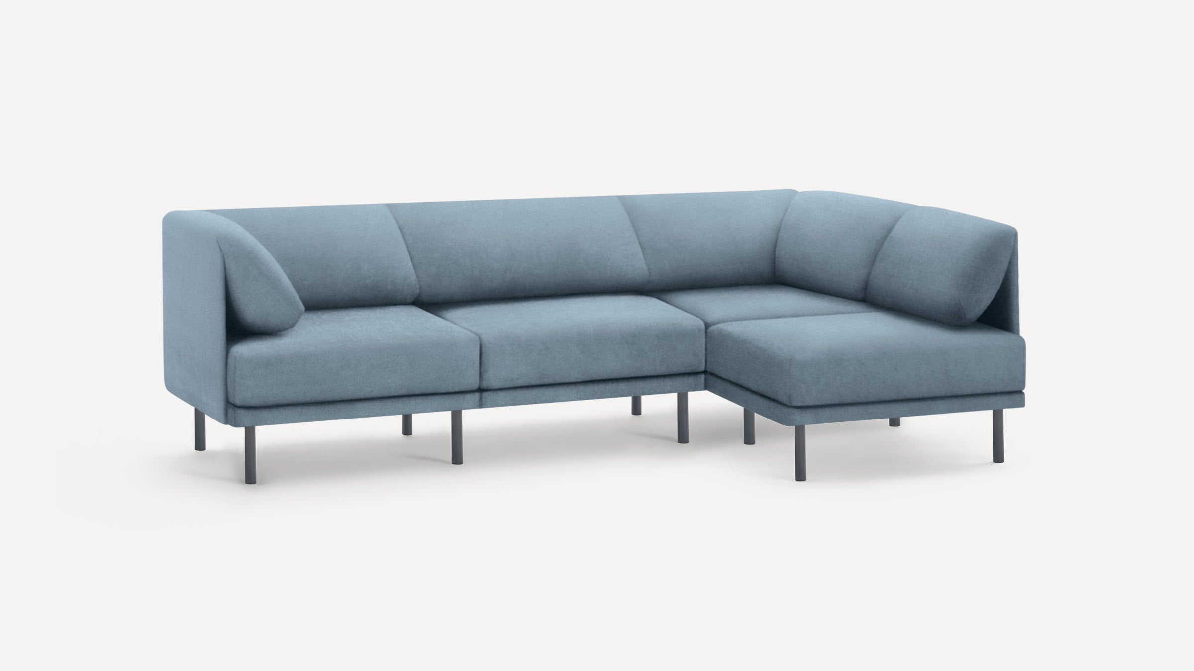 Modern light blue sectional sofa with slim black legs, featuring a chaise lounge on the right side, set against a white background.