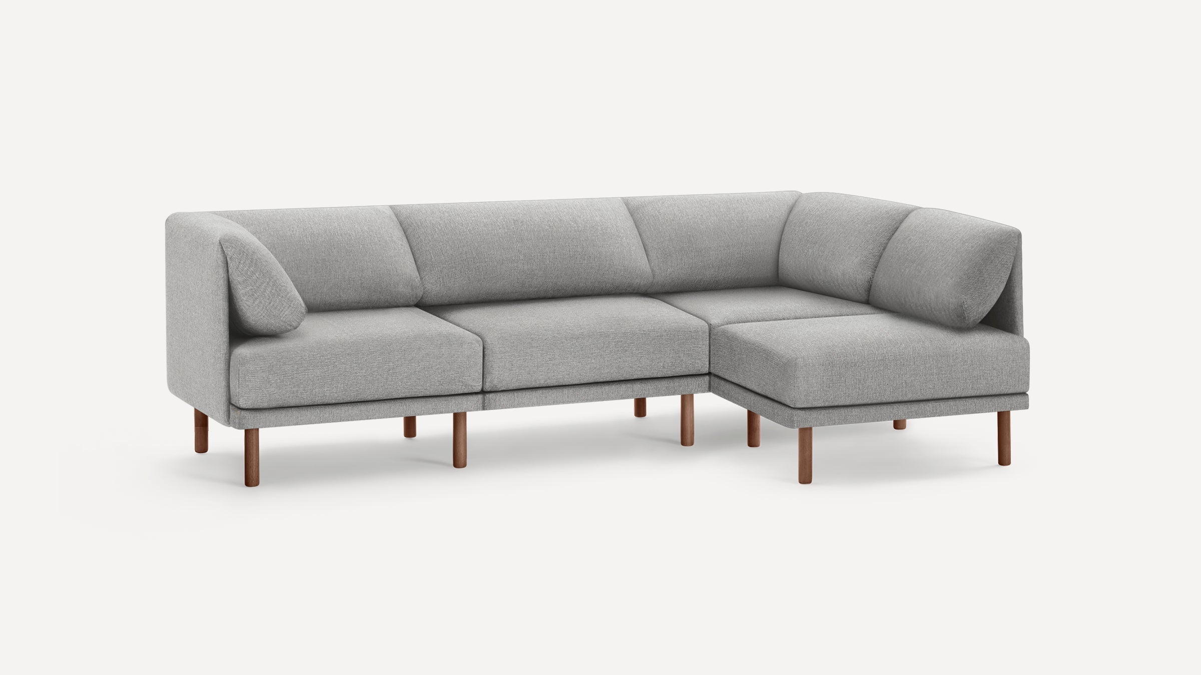 Modern L-shaped sectional sofa with light gray fabric upholstery and wooden legs on a plain white background.