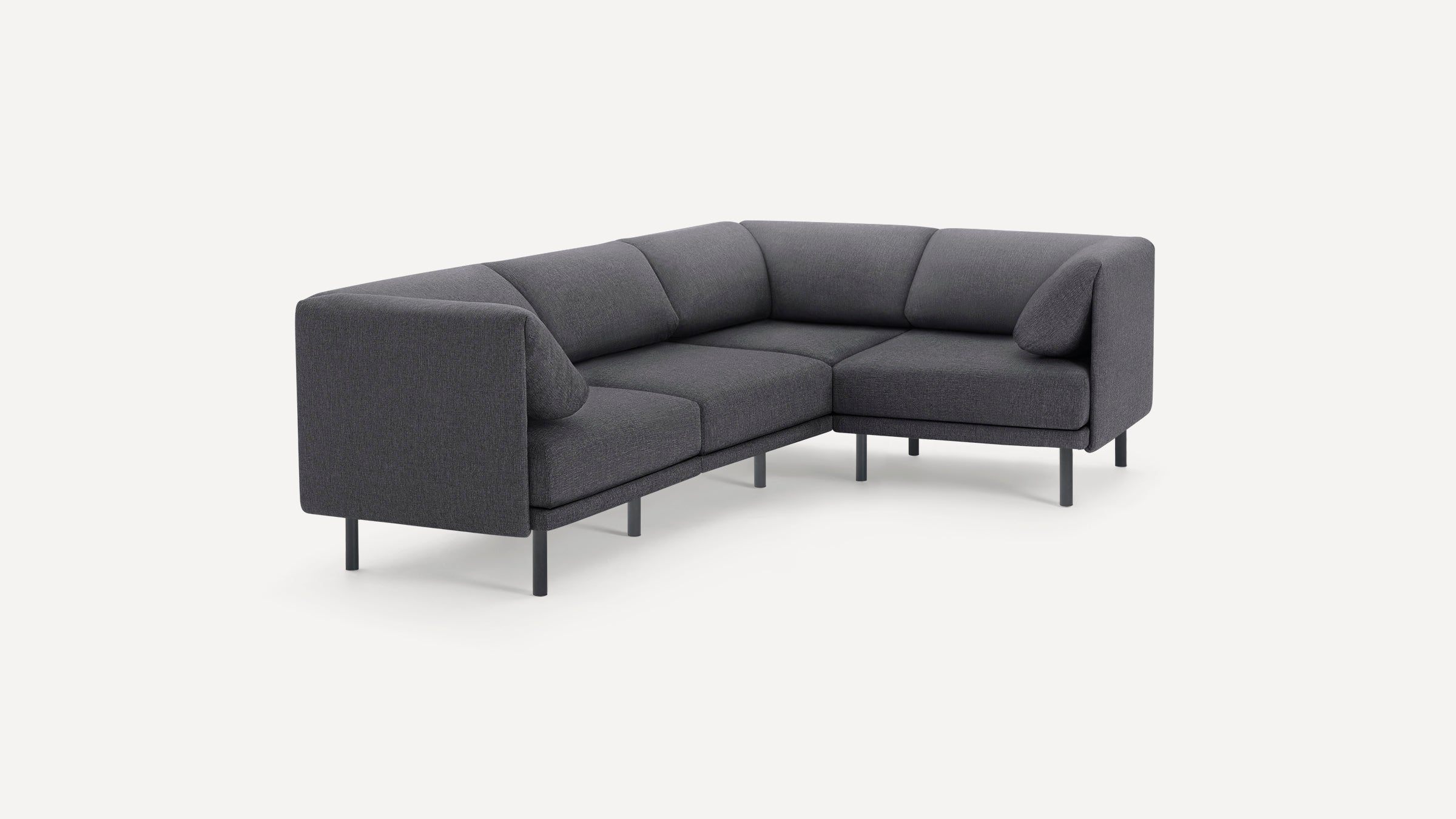 Modern dark gray fabric sectional sofa with clean lines, metal legs, and angled back cushions, shown on white background.